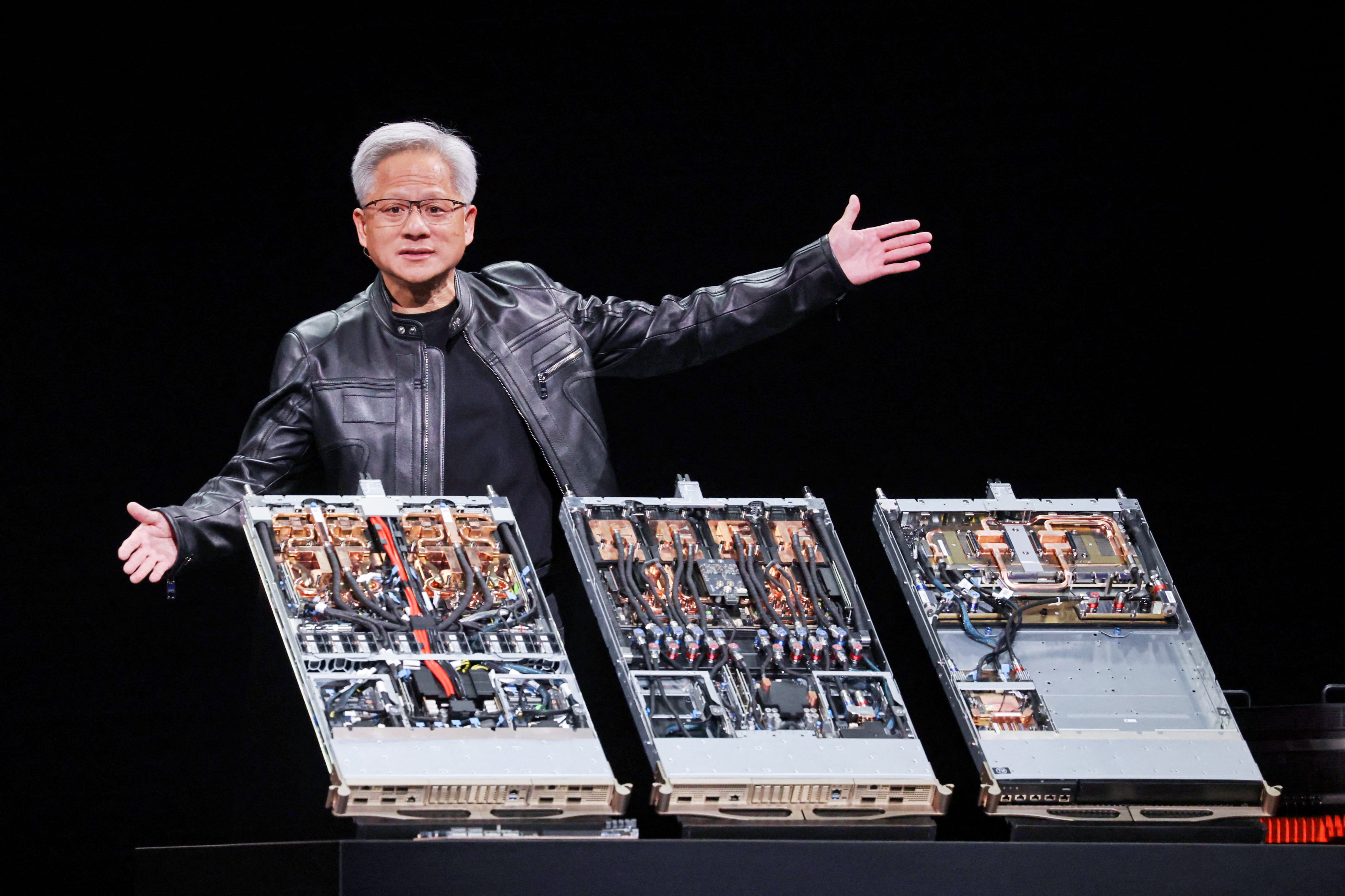 Jensen Huang with wide arms above circuit boards