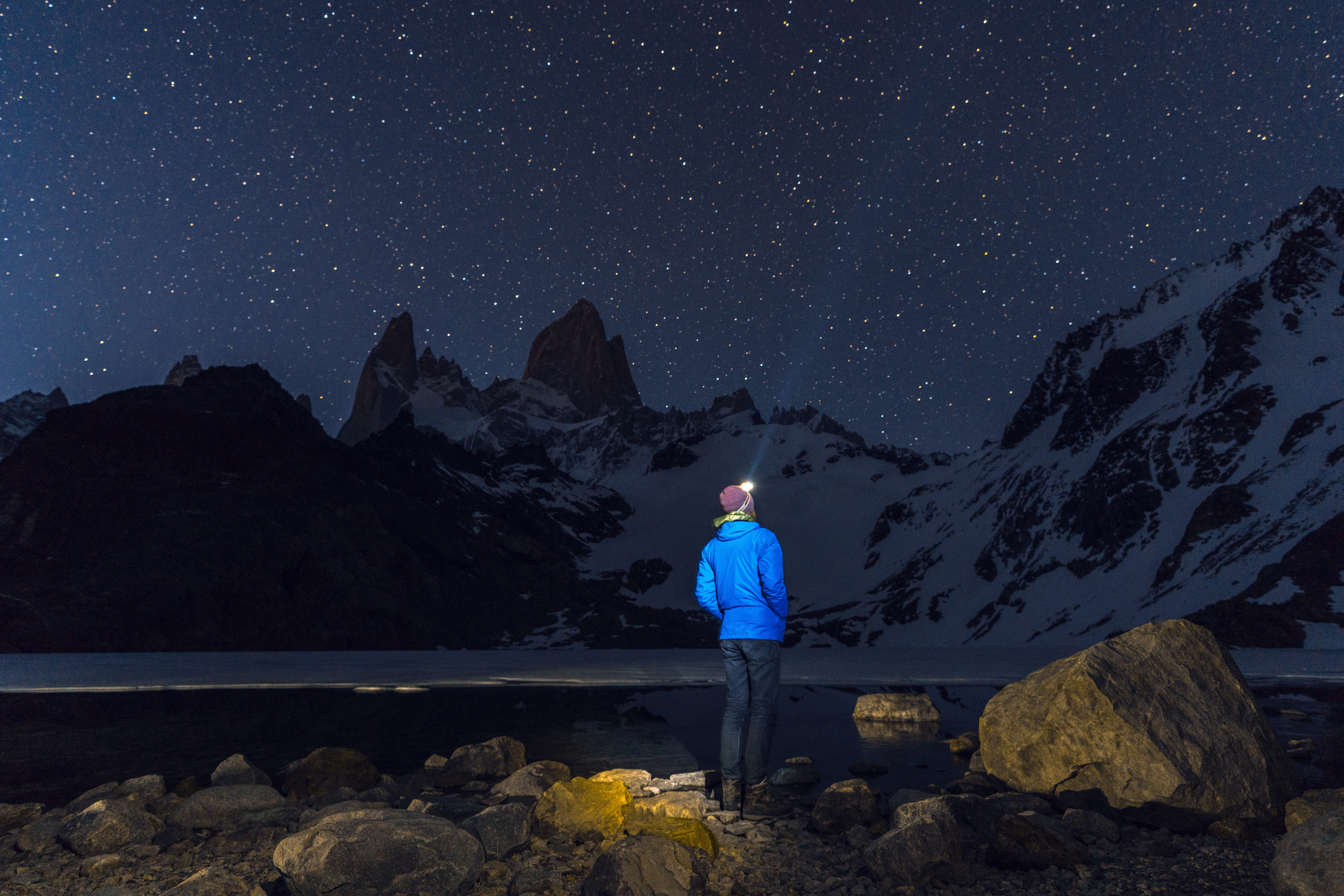 Man looking at stars in mountains