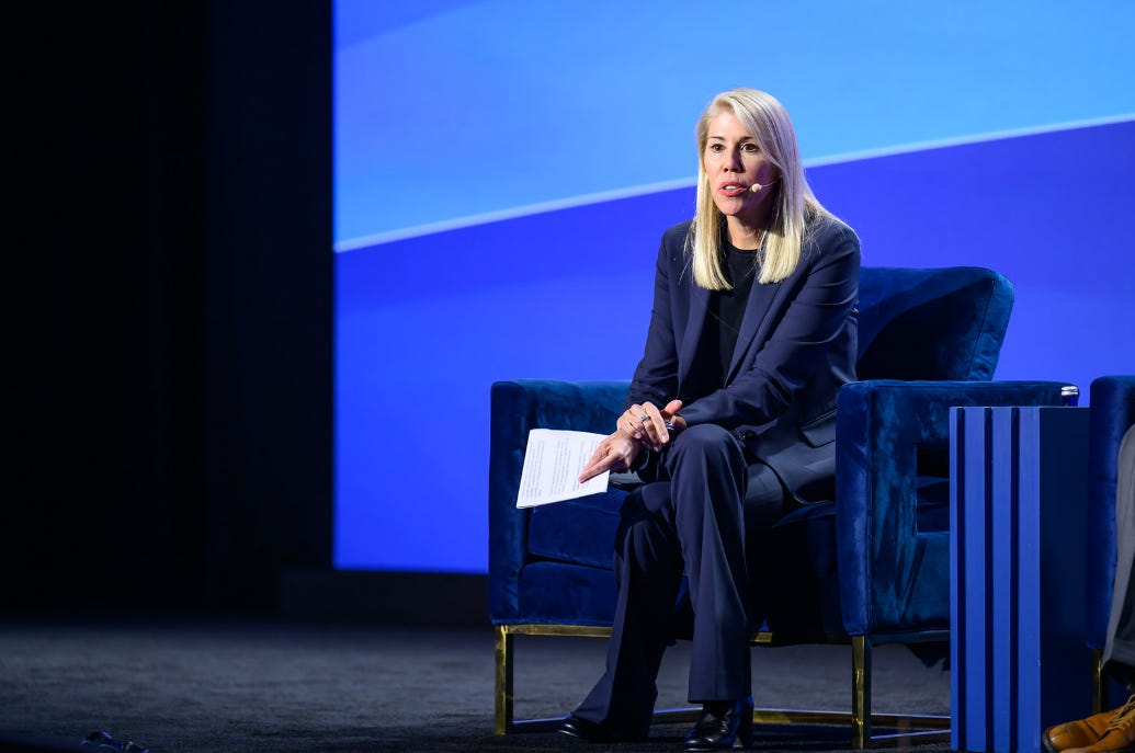 Jennifer Prosek, a female executive, presenting at the Milken Conference