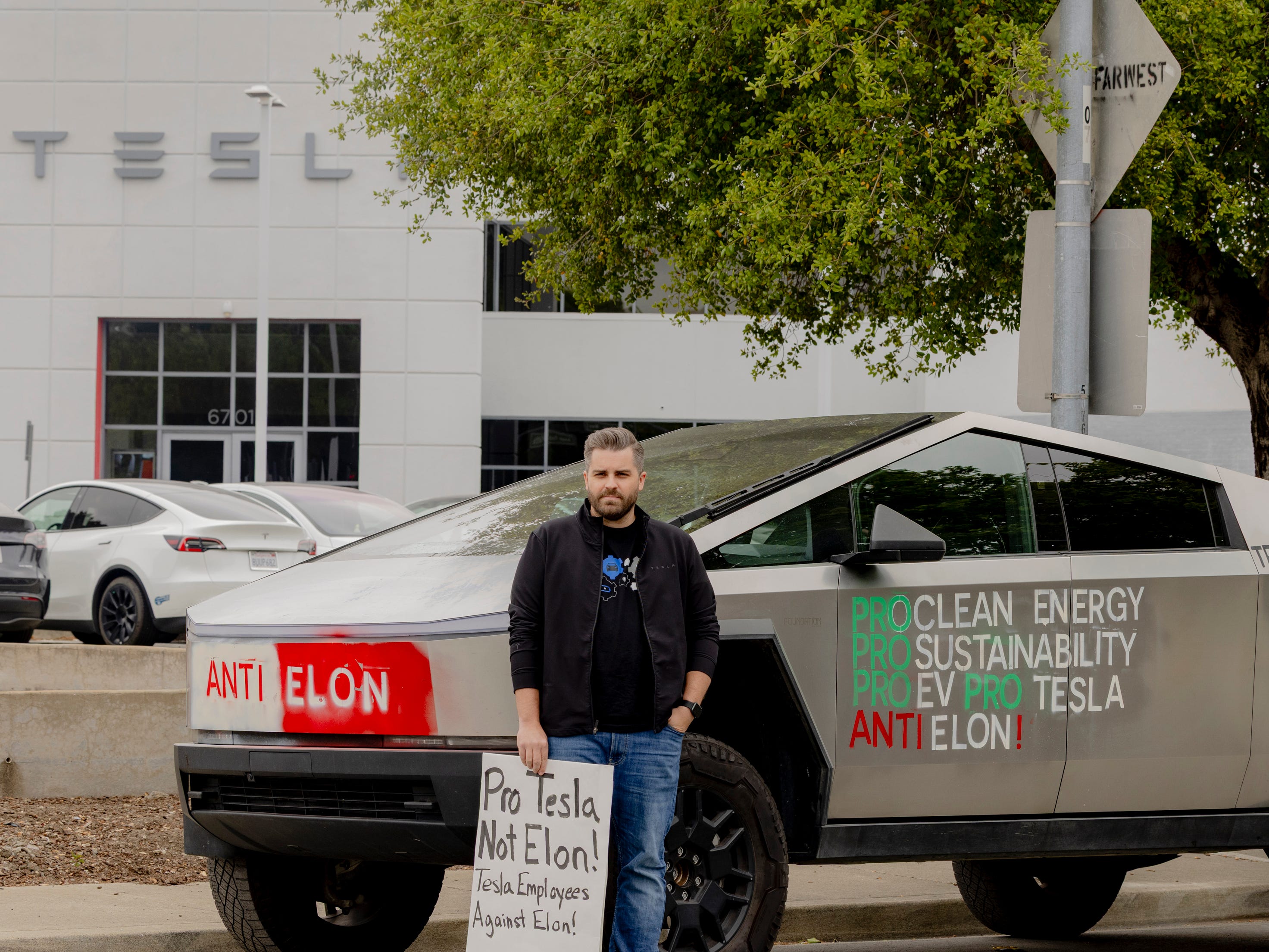 Matt Labrot stands in front of Tesla cyber truck and dealership.