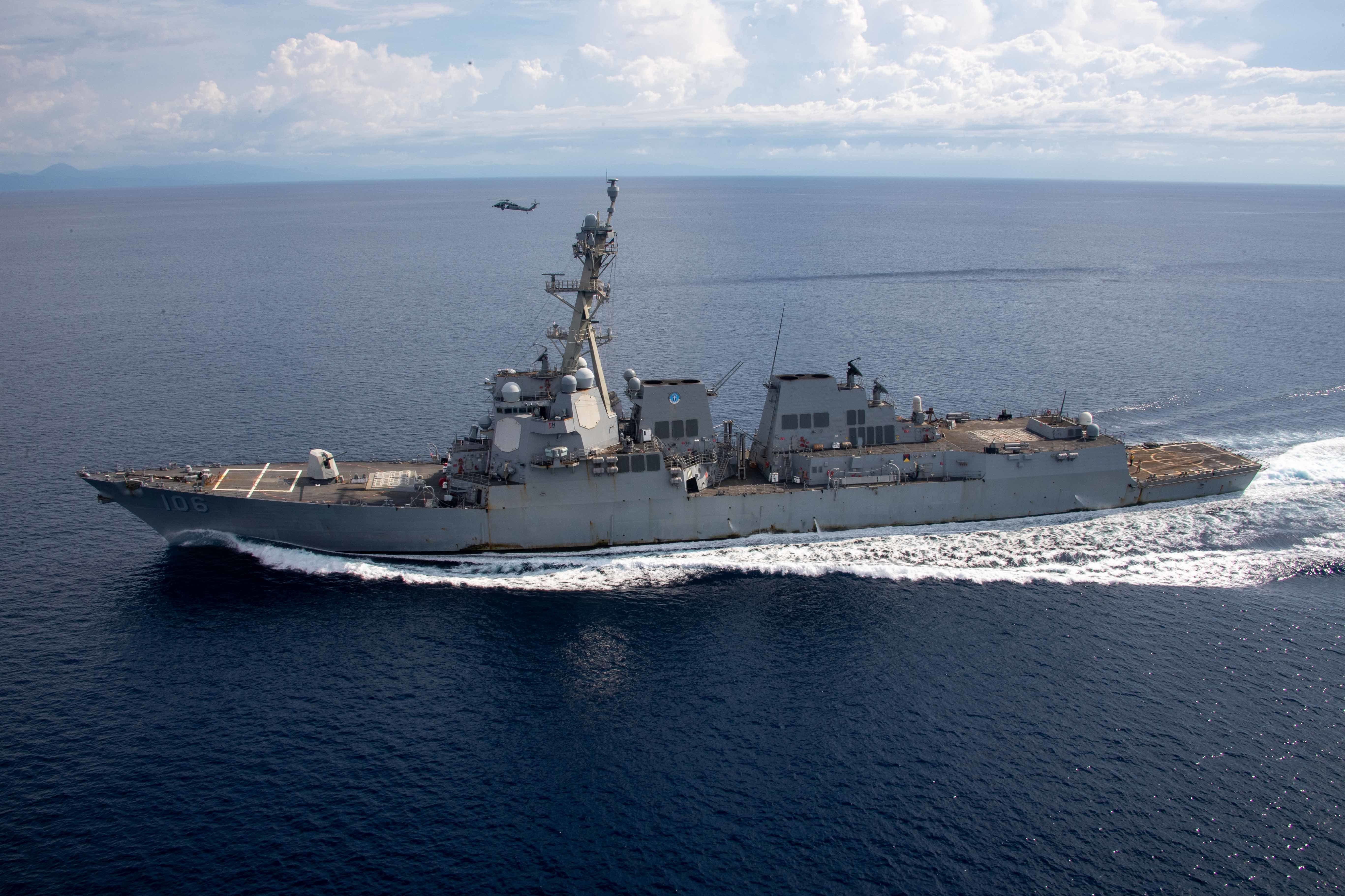 201218-N-TL932-1069 U.S. 7TH FLEET AREA OF RESPONSIBILITY (Dec. 18, 2021) An MH-60S Sea Hawk, assigned to "The Black Knights" of Helicopter Sea Combat Squadron (HSC) 4, participates in dry rope exercises with Arleigh Burke-class guided-missile destroyer USS Stockdale (DDG 106) Dec. 18, 2021.