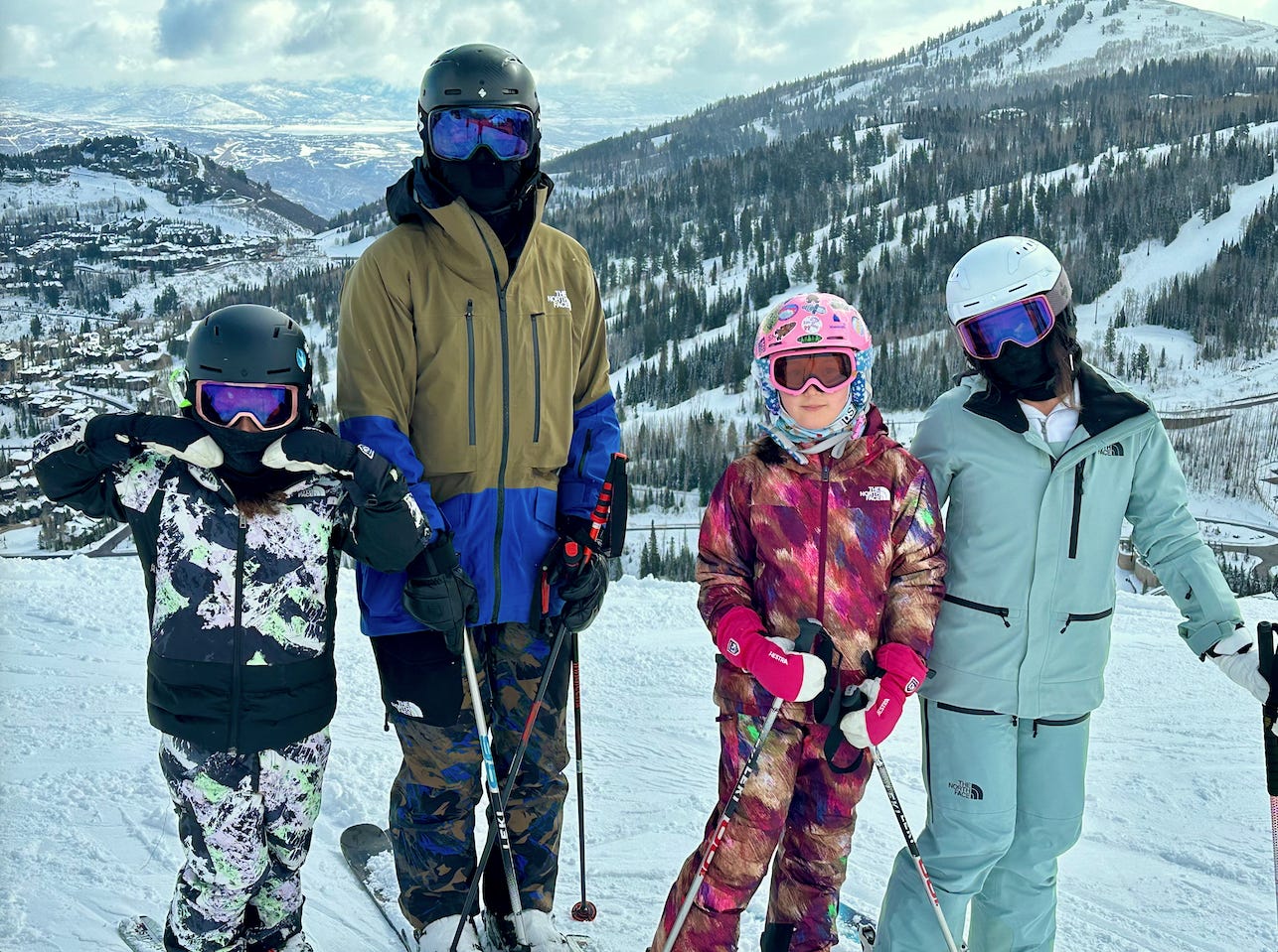 Justin Ghio skiing with his fiancé and twin daughters.
