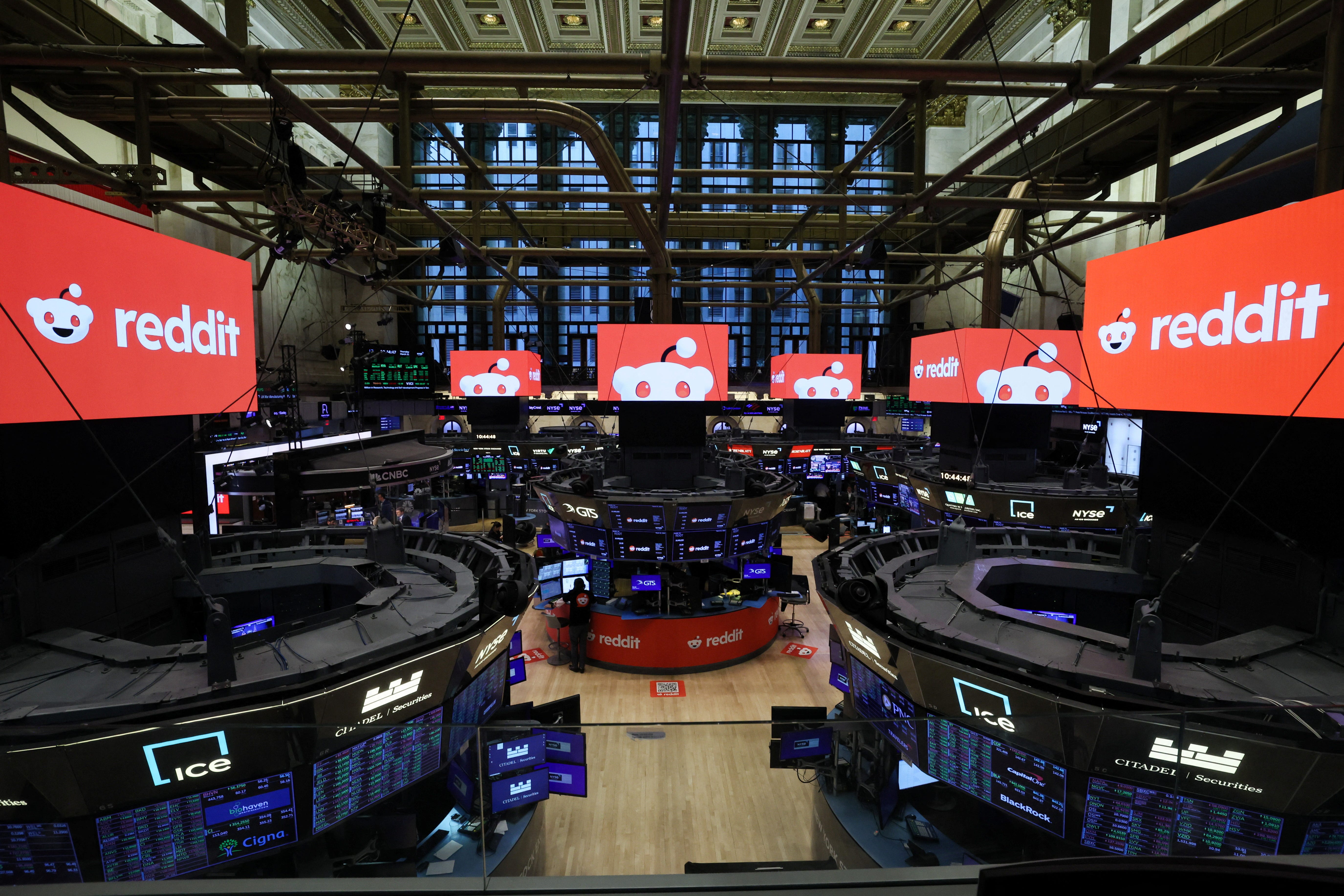 Television screens display the Reddit logo at the New York Stock Exchange.