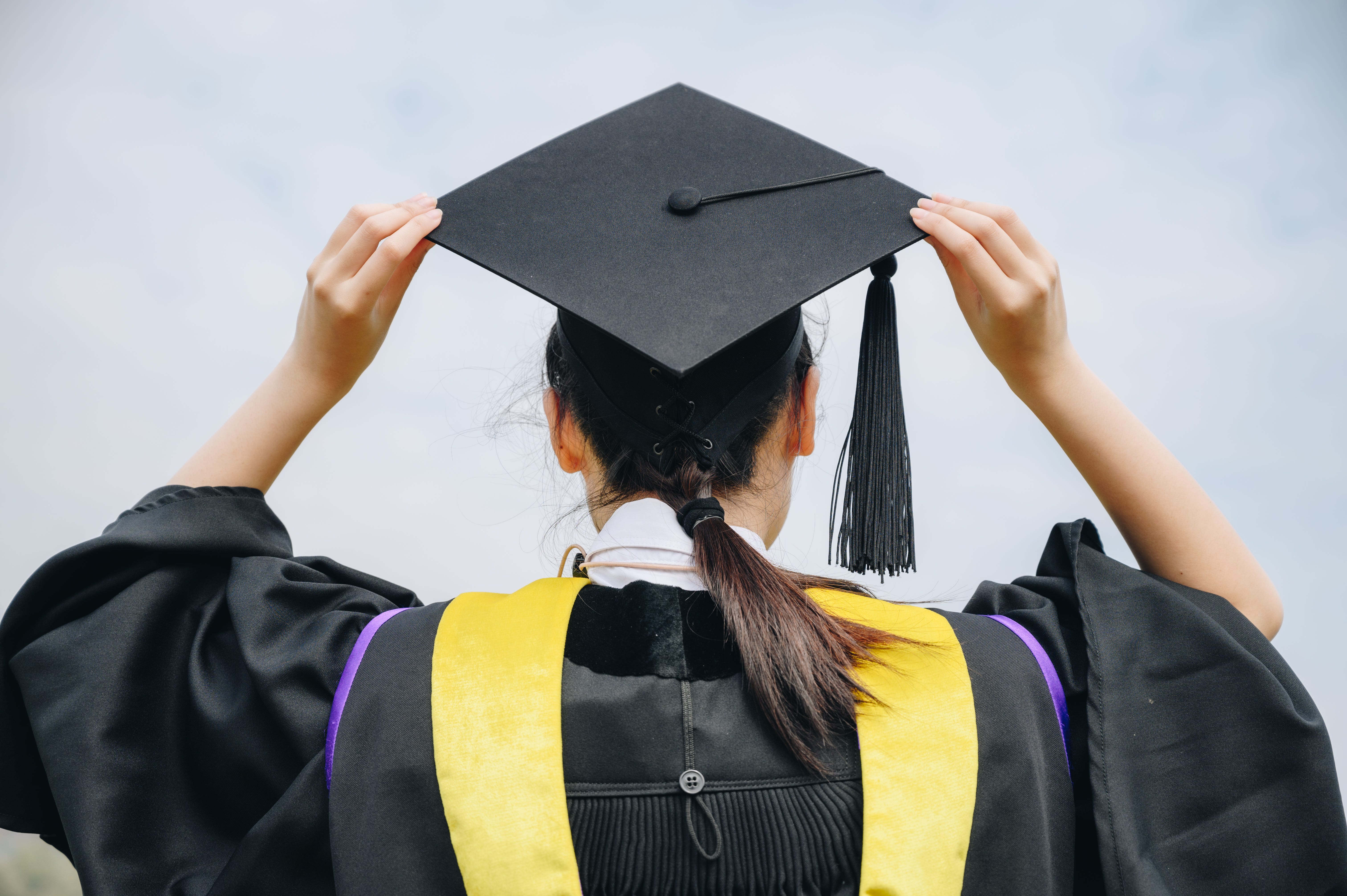 A woman wearing a cap and gown.