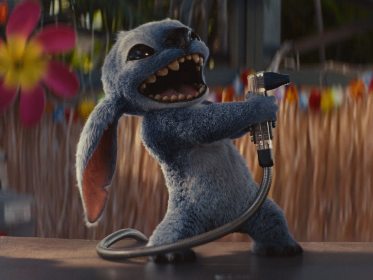 Stitch spraying a drink dispenser while standing on a bar in "Lilo and Stitch"