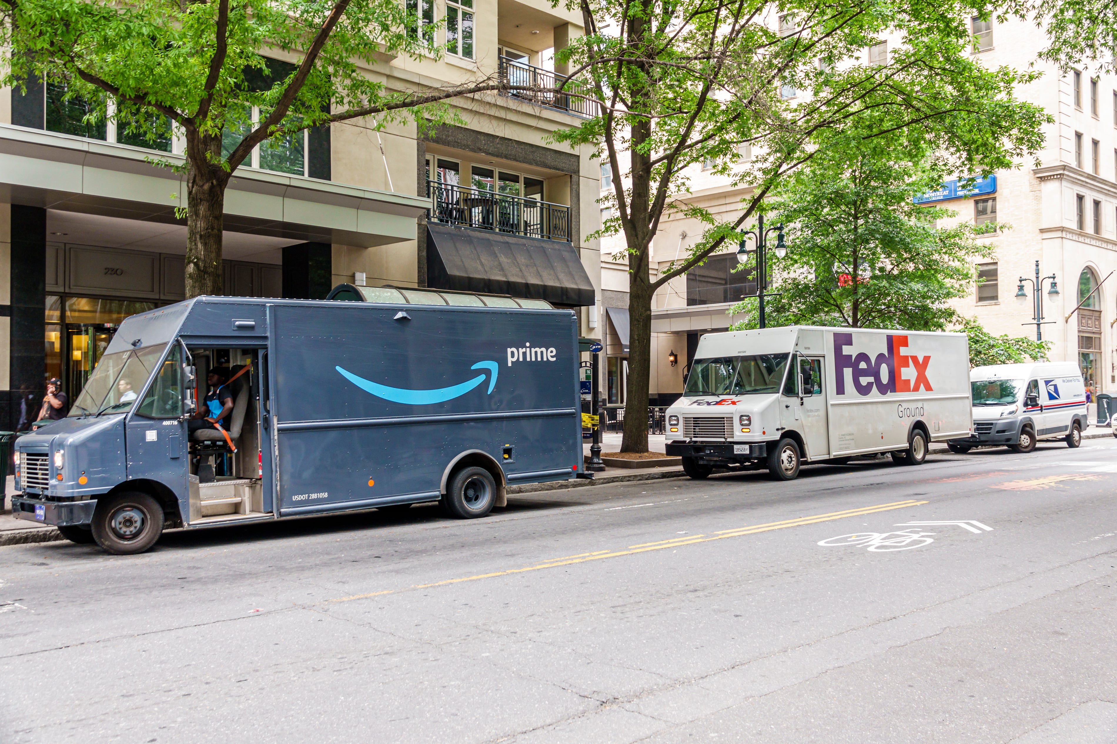 Amazon and FedEx trucks together