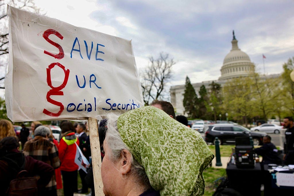 woman holding a "save our social security" sign with the capitol in the background