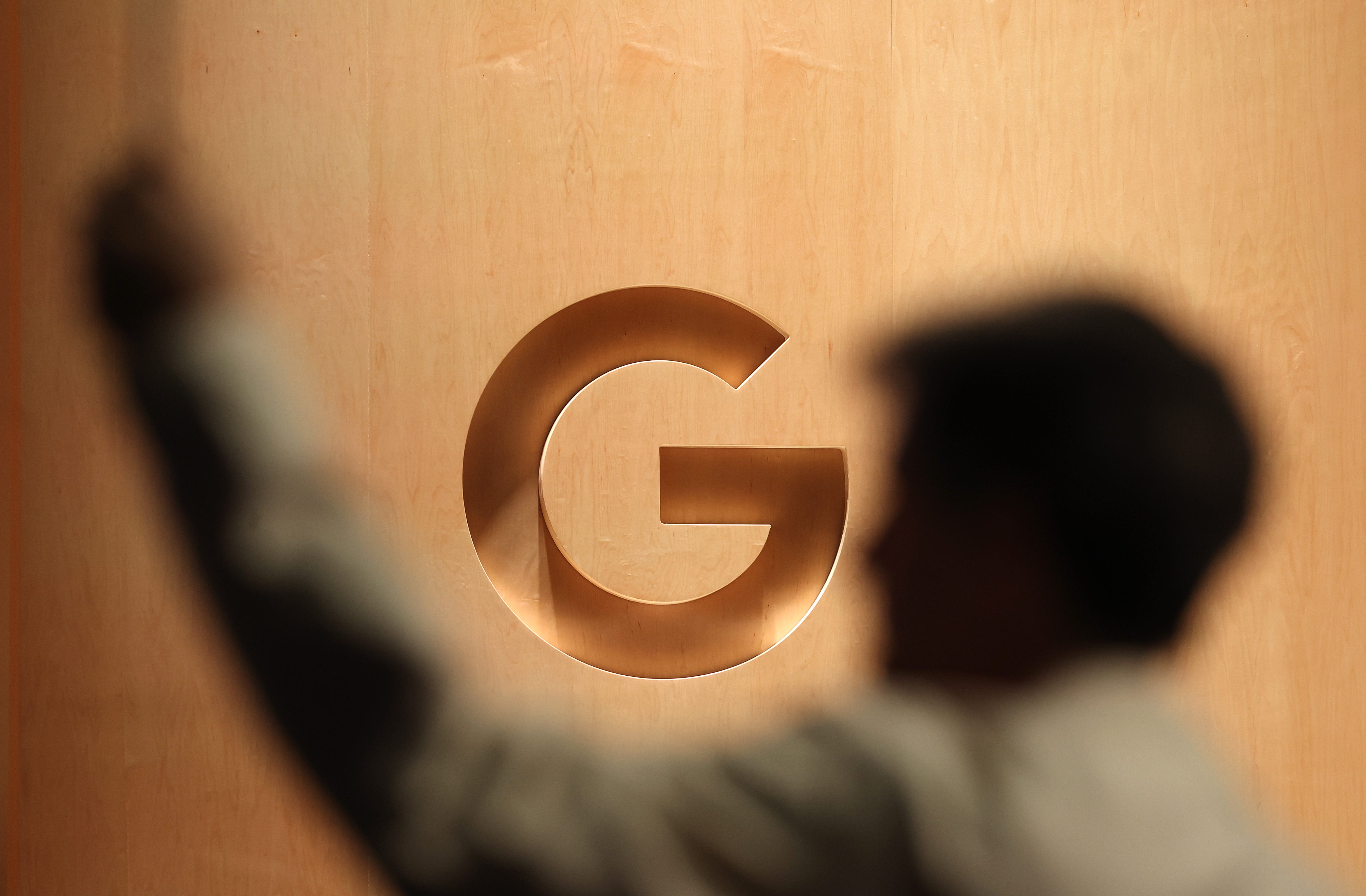 A google logo with a person blurred in the foreground.