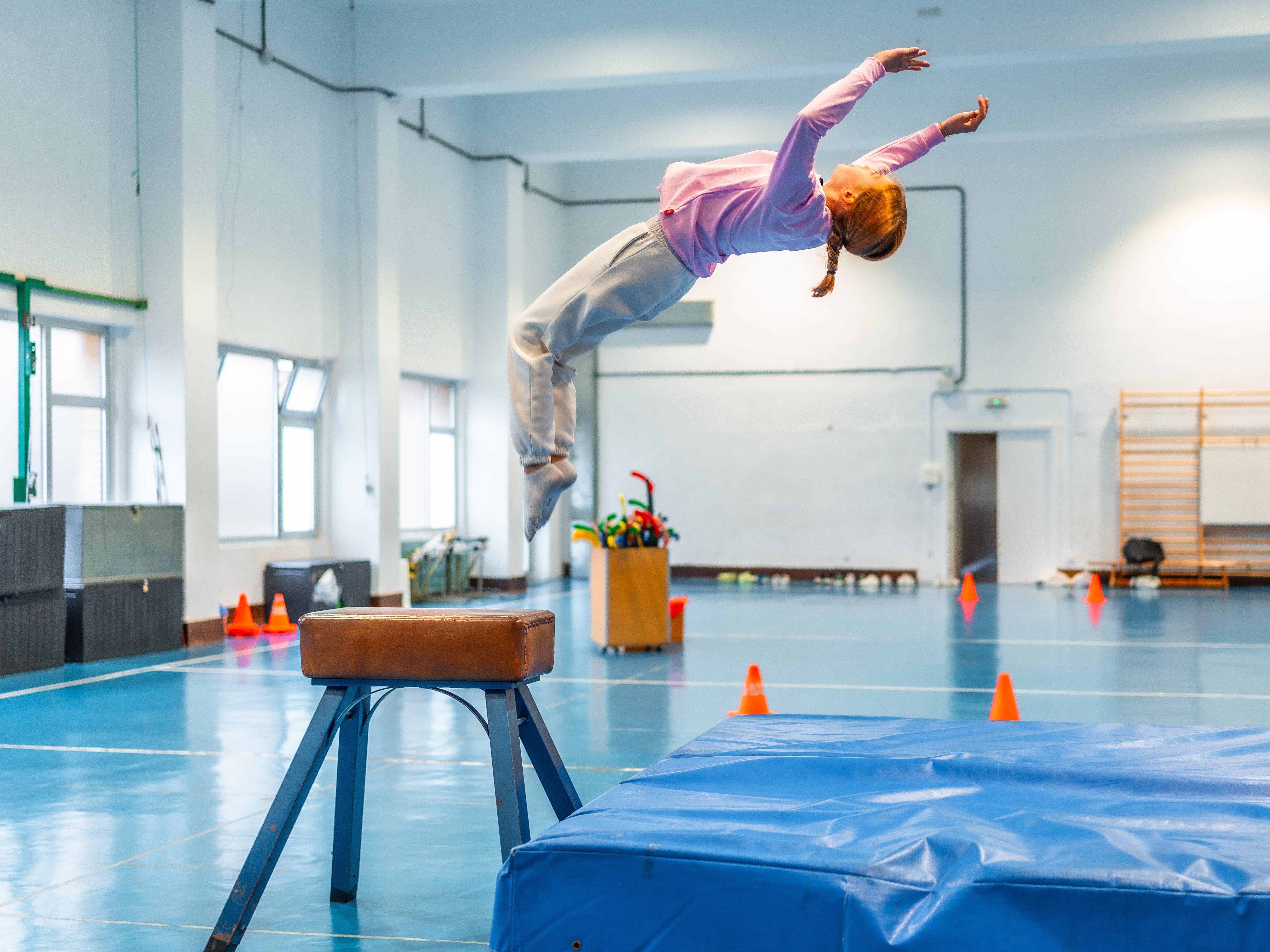 a child gymanst flipping through the air