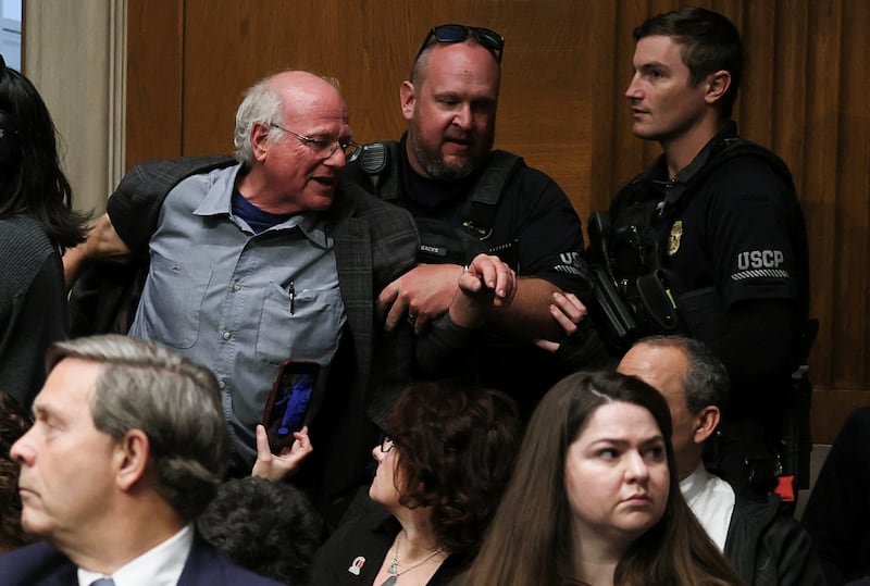 Ben Cohen, co-founder of ice cream company Ben & Jerry’s, is removed by U.S. Capitol Police, as U.S. Health and Human Services (HHS) Secretary Robert F. Kennedy Jr. (Not Pictured) testifies before a Senate Health, Education, Labor & Pensions Committee hearing on the Department of Health and Human Services budget, on Capitol Hill in Washington, D.C., U.S., May 14, 2025. REUTERS/Leah Millis