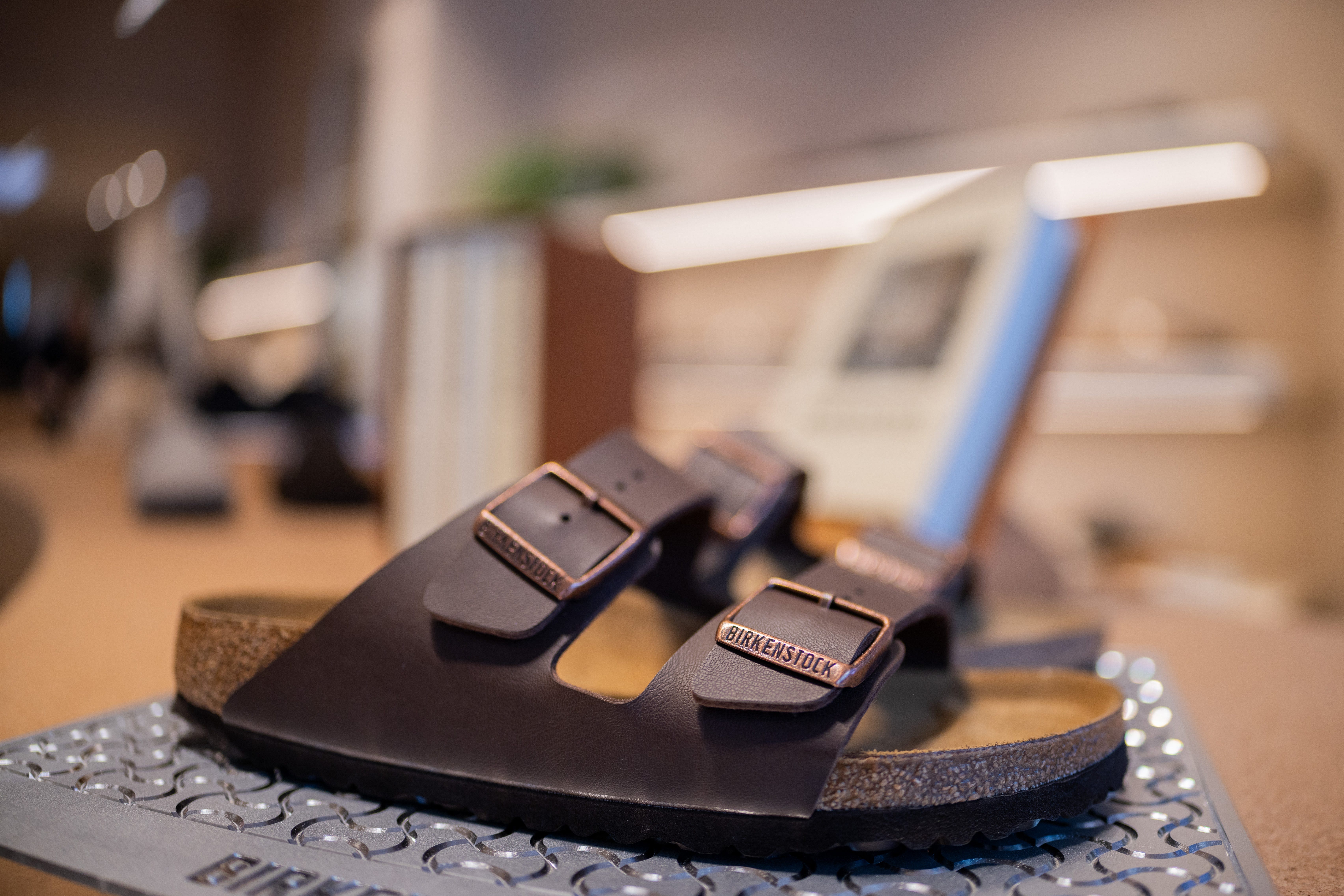 Various Birkenstock shoes are displayed on shelves in a Birkenstock store on Ehrenstraße.