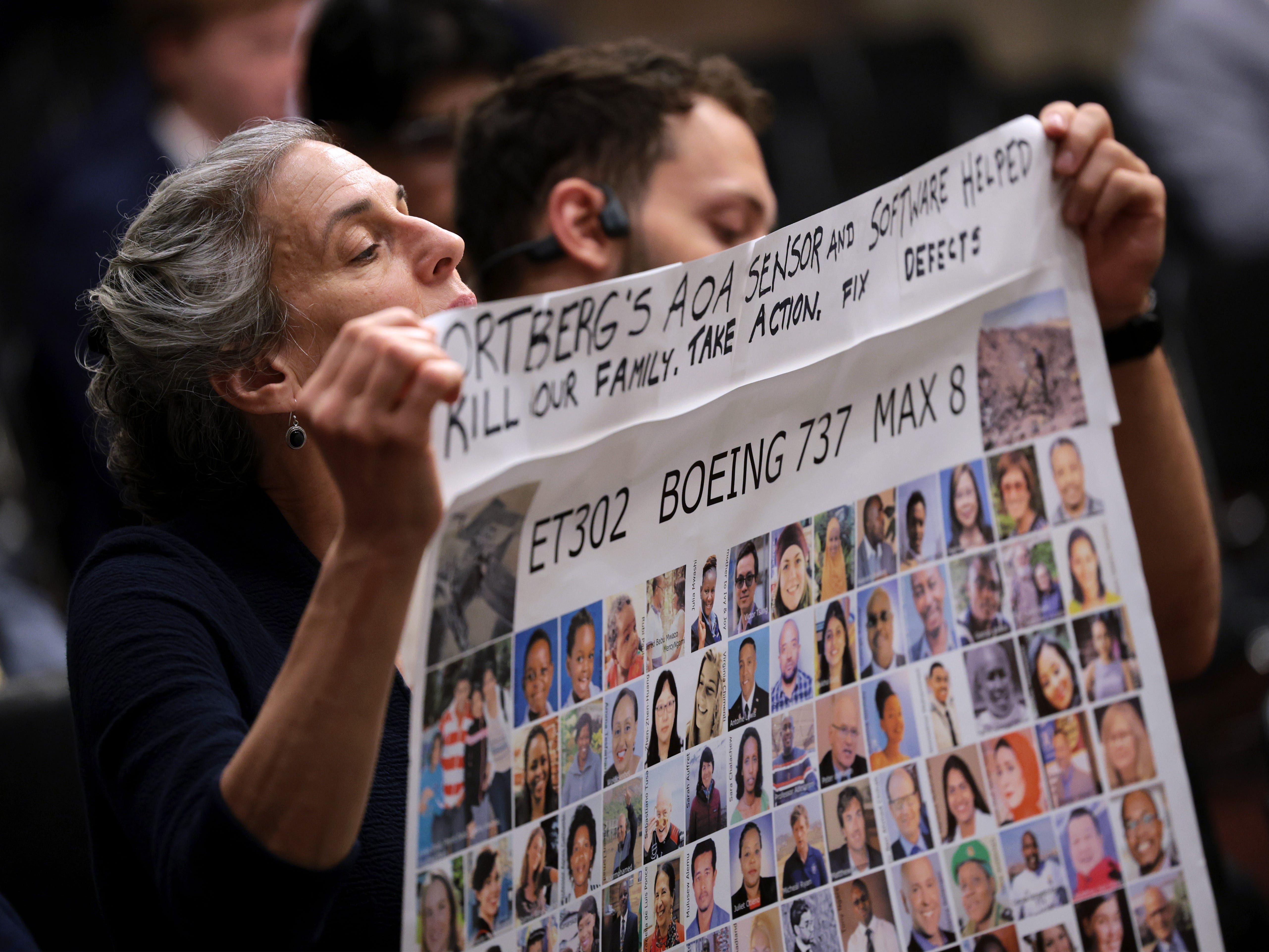 Family members of victims of the Ethiopian Airlines Boeing 737 MAX 8 crash hold a sign as President and CEO of Boeing Kelly Ortberg prepares to testify before the Senate