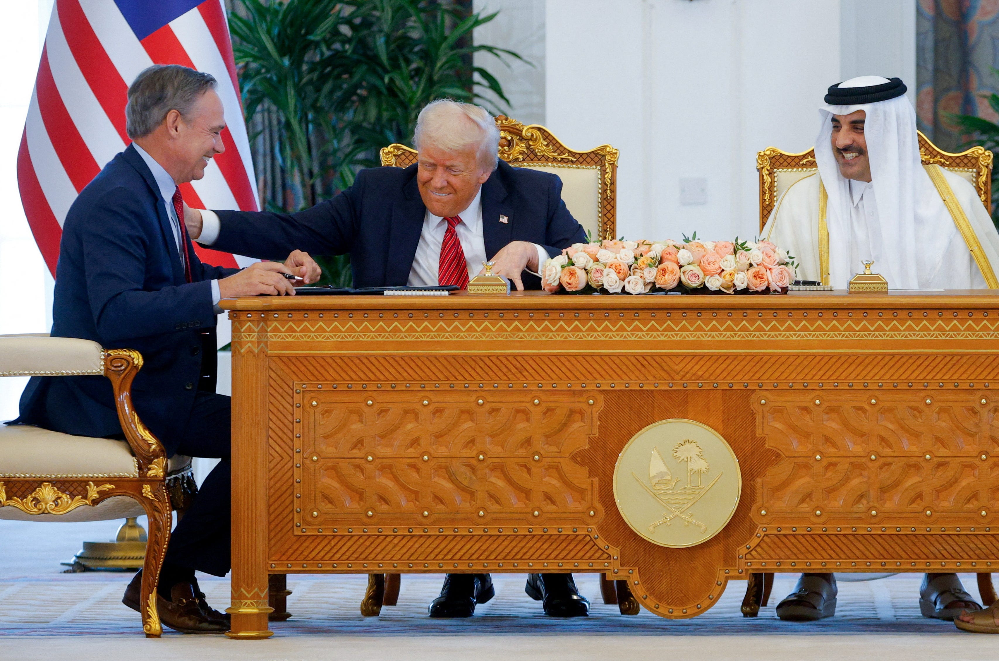 U.S. President Donald Trump, Qatar's Emir Tamim bin Hamad Al Thani and Boeing CEO Kelly Ortberg attend a signing ceremony in Doha, Qatar, May 14, 2025