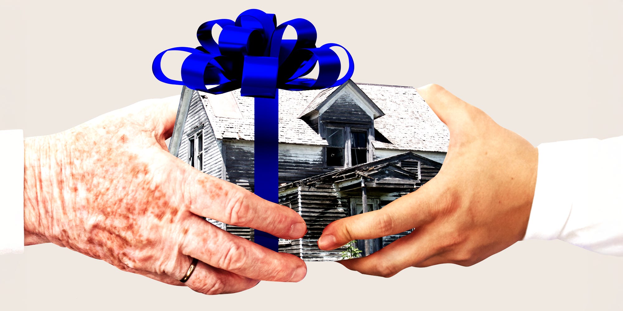 An older hand passing a dilapidated house with a big blue bow to a younger hand.