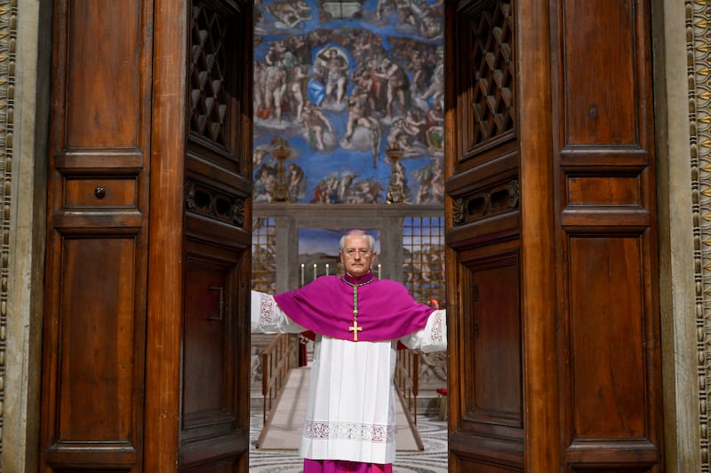 Archbishop Diego Giovanni Ravelli closes the doors of the Sistine Chapel ahead of the conclave to elect the next pope.
