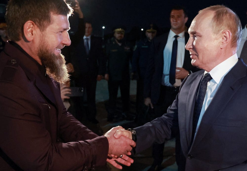 Russia's President Vladimir Putin, viewed side-on, shakes hands with the Chechen Republic Ramzan Kadyrov as they meet at an airport in Grozny, Russia August 20, 2024. Image supplied by state media.