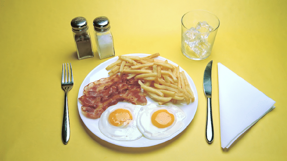 A GIF of a breakfast plate being taken away.