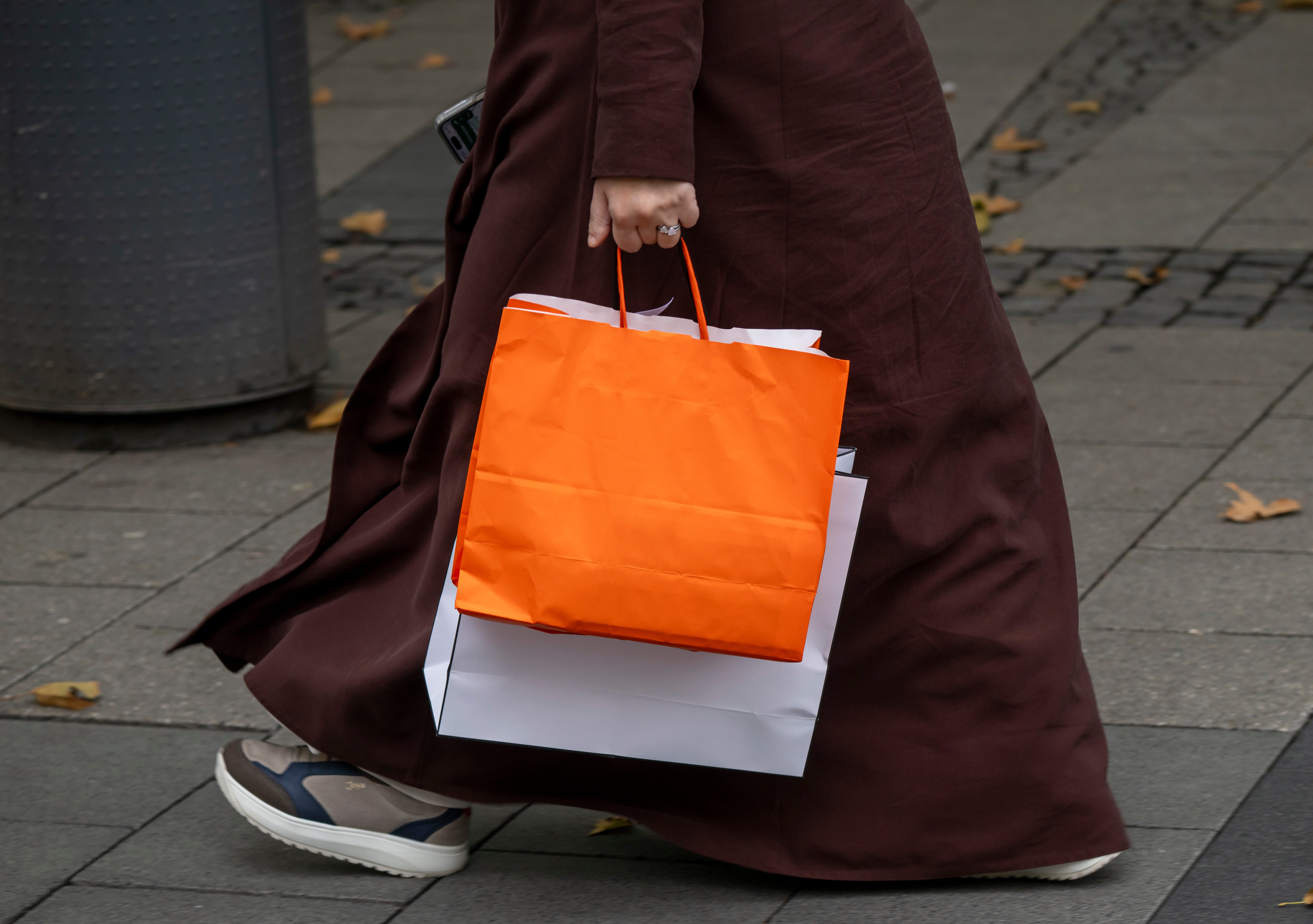 A woman holds shopping bags