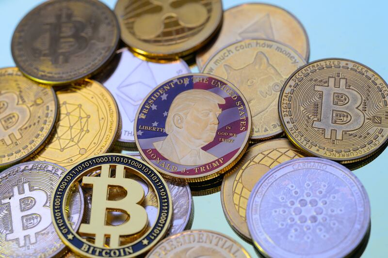 A photo illustration shows a representation of cryptocracy coins with the $Trump meme coin (collection coin) in Brussels, Belgium.