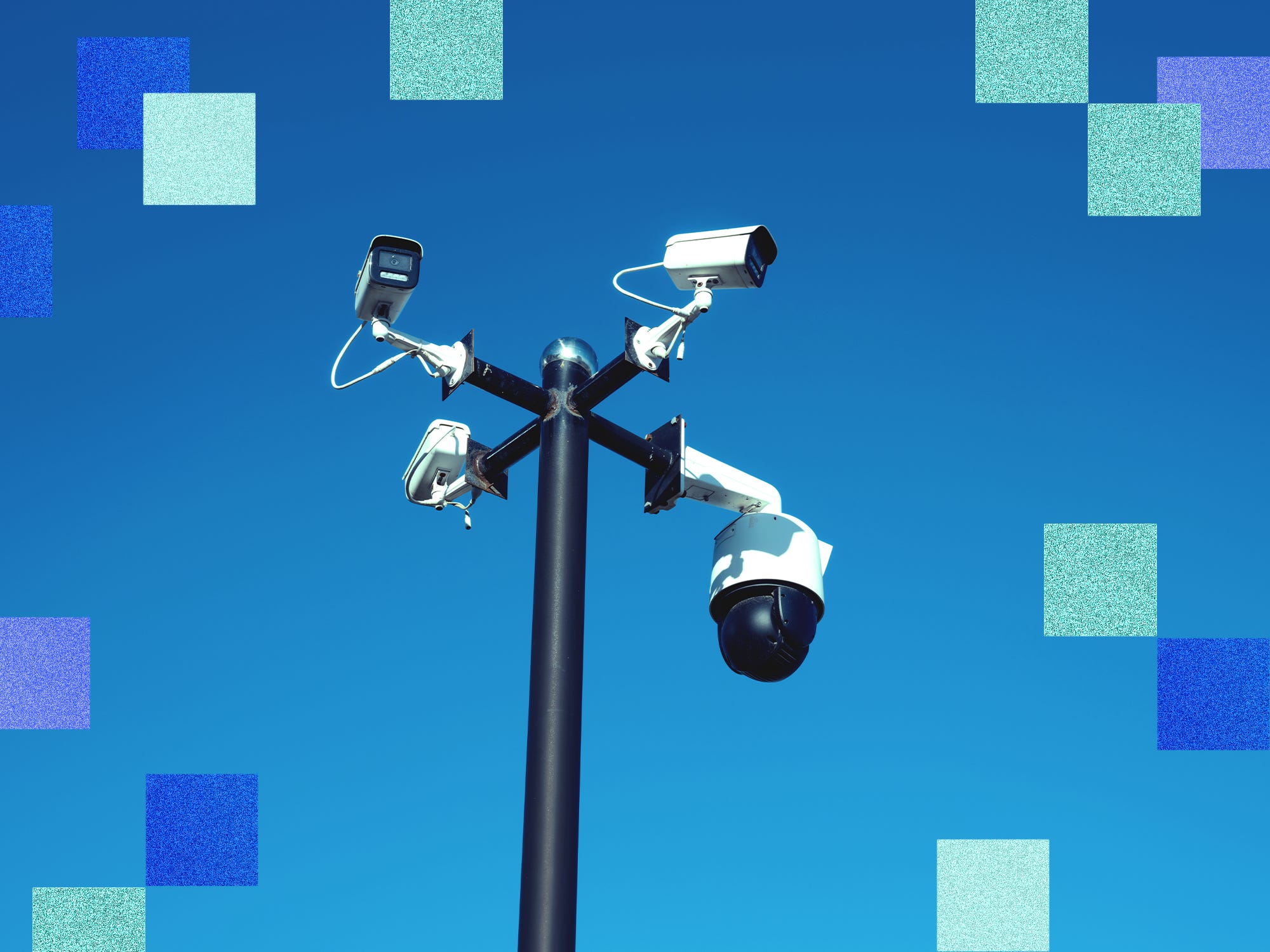 Security cameras against blue sky
