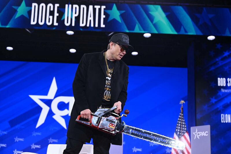 Elon Musk with chainsaw
