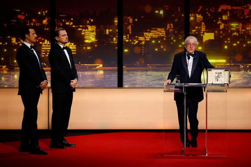 Robert De Niro receives an Honorary Palme d'Or Award next to Leonardo DiCaprio and Master of Ceremony Laurent Lafitte