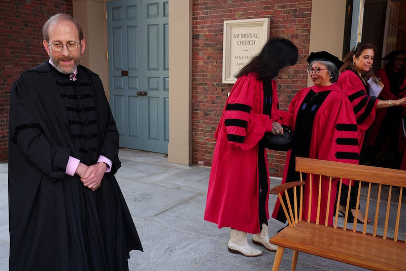 Harvard President Alan Garber waits for honorary degree recipients to assemble at a ceremony in 2024. These days, he is fighting against President Donald Trump’s threats to end Harvard’s tax-exempt status and to permanently cut off its federal funding.