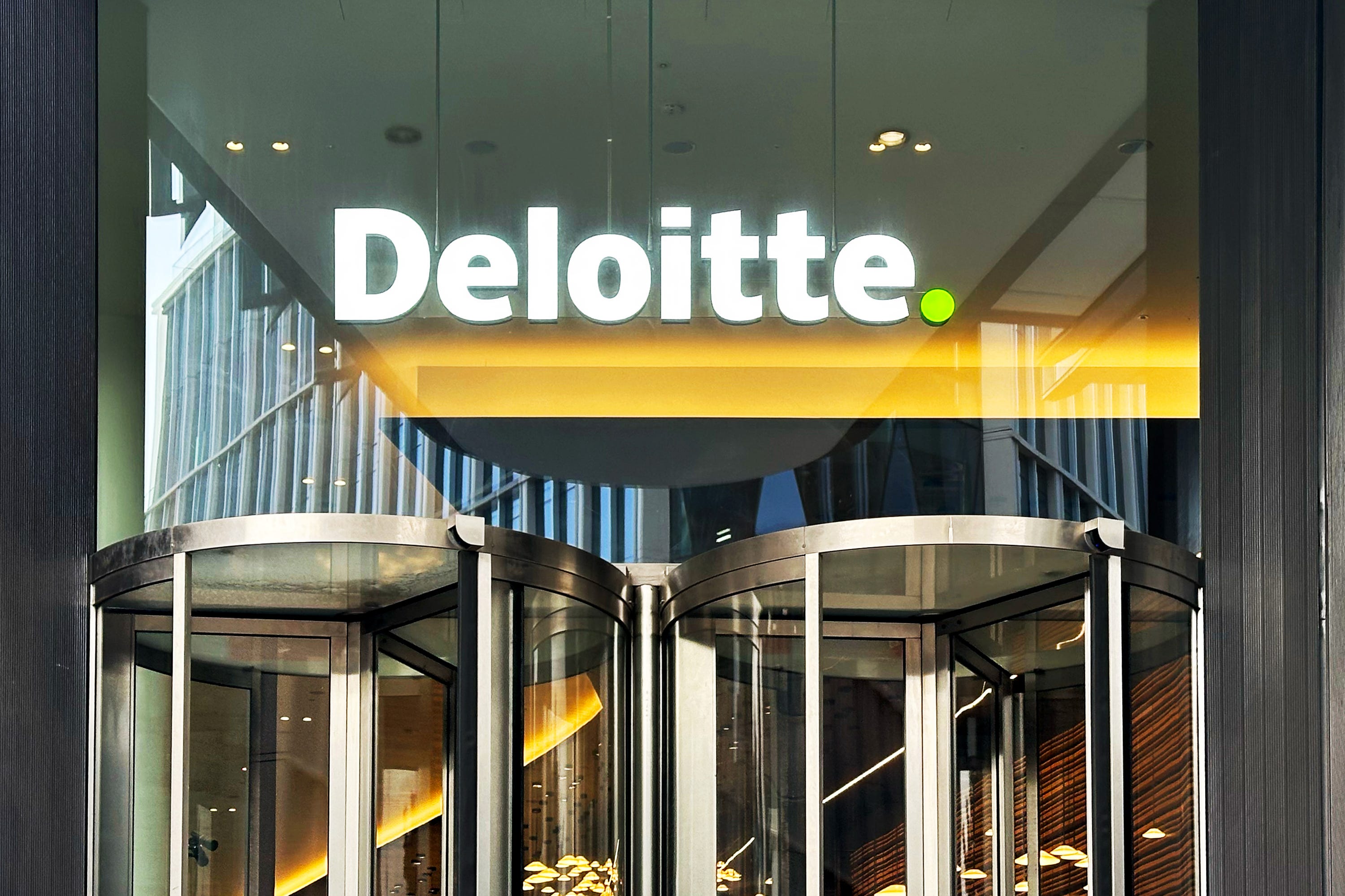 Deloitte logo above two revolving doors