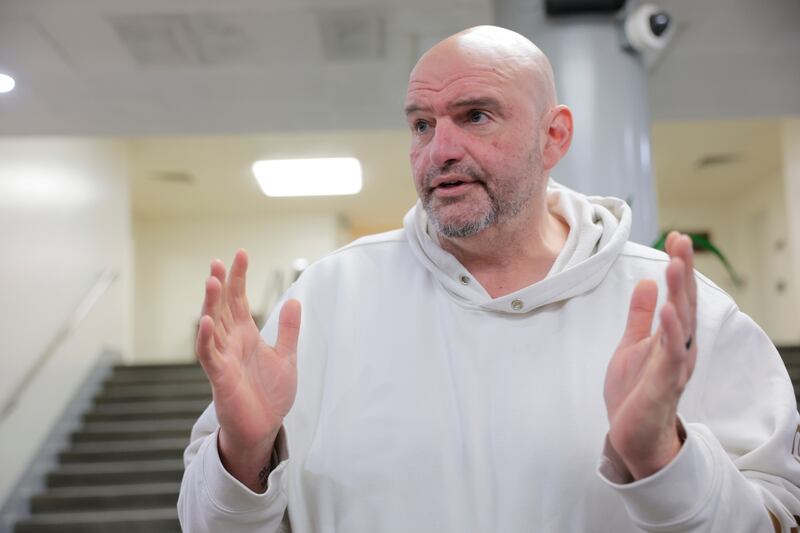 WASHINGTON, DC - FEBRUARY 12: U.S. Sen. John Fetterman (D-PA) speaks to reporters in the Senate Subway during a series of confirmation votes for U.S. President Donald Trump's cabinet nominees at the U.S. Capitol Building on February 12, 2025 in Washington, DC. The Senate voted to confirm Tulsi Gabbard as Director of National Intelligence and completed a procedural vote for the confirmation of Robert F. Kennedy Jr. as Secretary of Health and Human Services. (Photo by Anna Moneymaker/Getty Images)