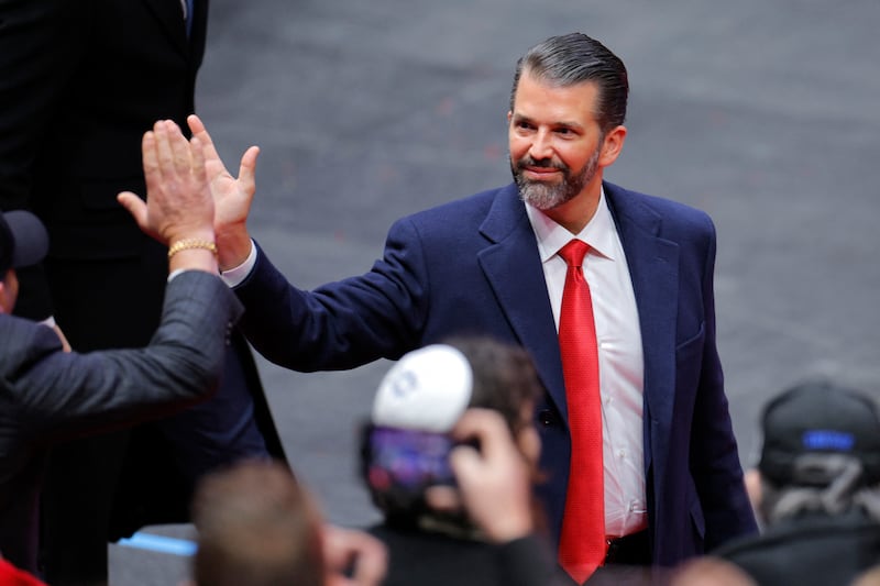 Donald Trump Jr. high fives a member of the crowd at Capital One arena on the inauguration day of Donald Trump's second presidential term.