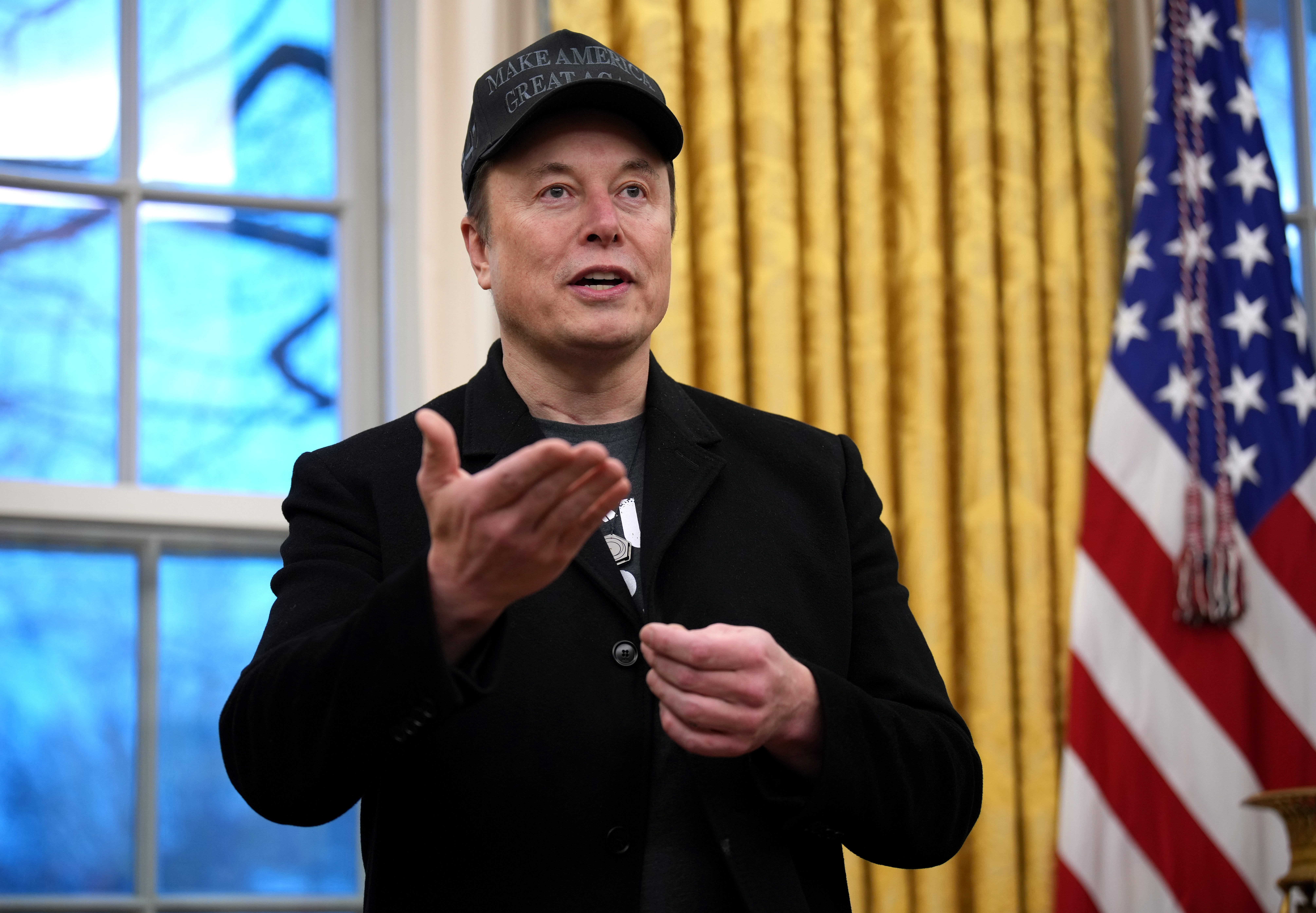 Elon Musk speaking to reporters in the Oval Office at the White House.