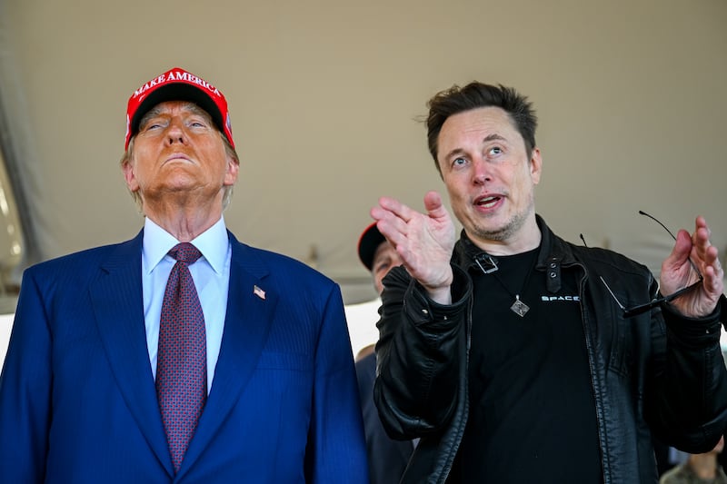 BROWNSVILLE, TEXAS - NOVEMBER 19: Elon Musk speaks with U.S. President-elect Donald Trump as they watch the launch of the sixth test flight of the SpaceX Starship rocket on November 19, 2024 in Brownsville, Texas.