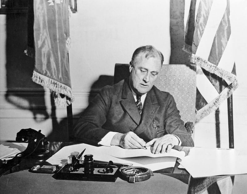 Franklin D. Roosevelt signs the Emergency Banking Act on March 9, 1933.