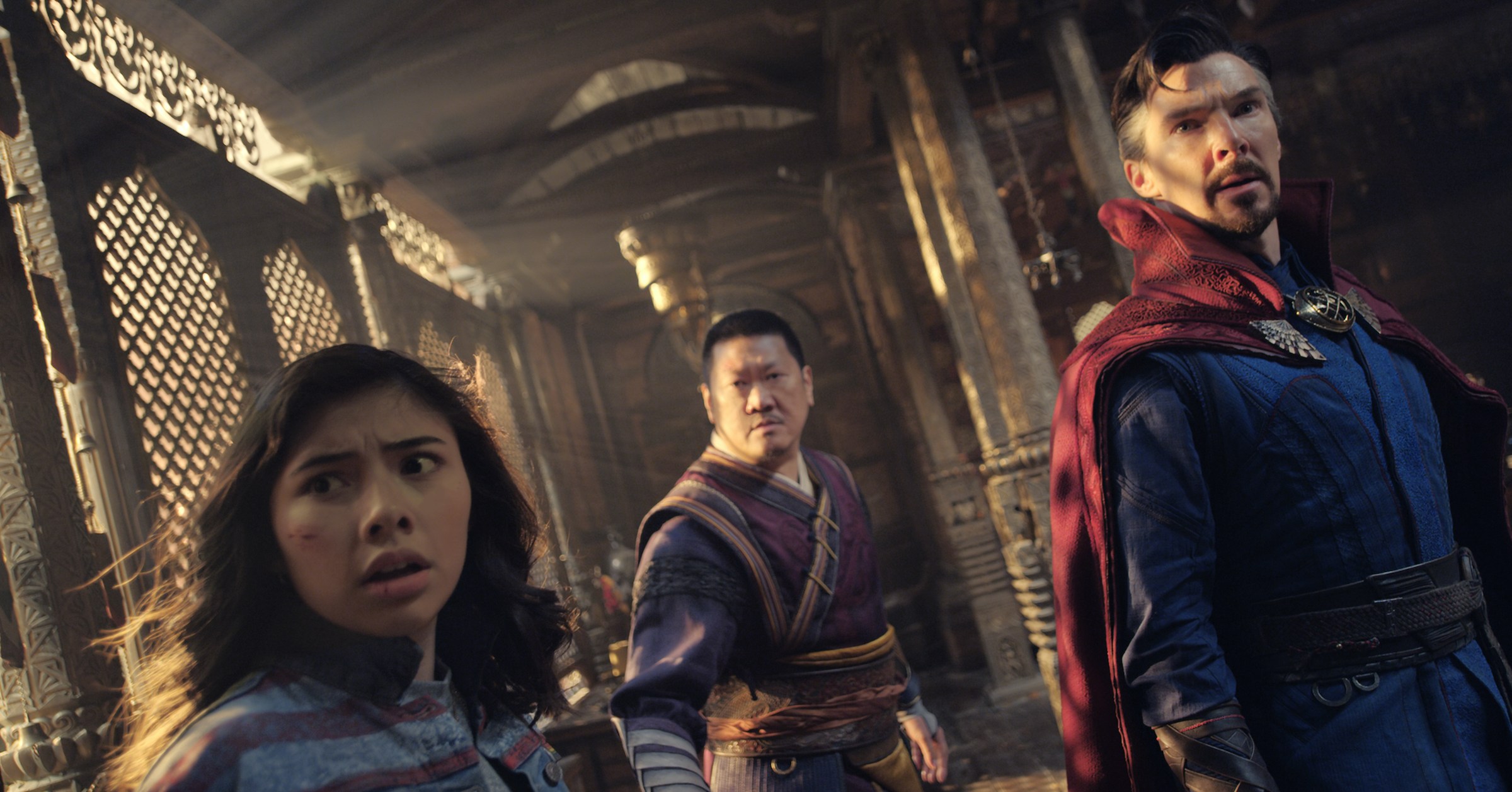 America Chavez, Wong, and Doctor Strange look anxiously toward the camera in Doctor Strange in the Multiverse of Madness