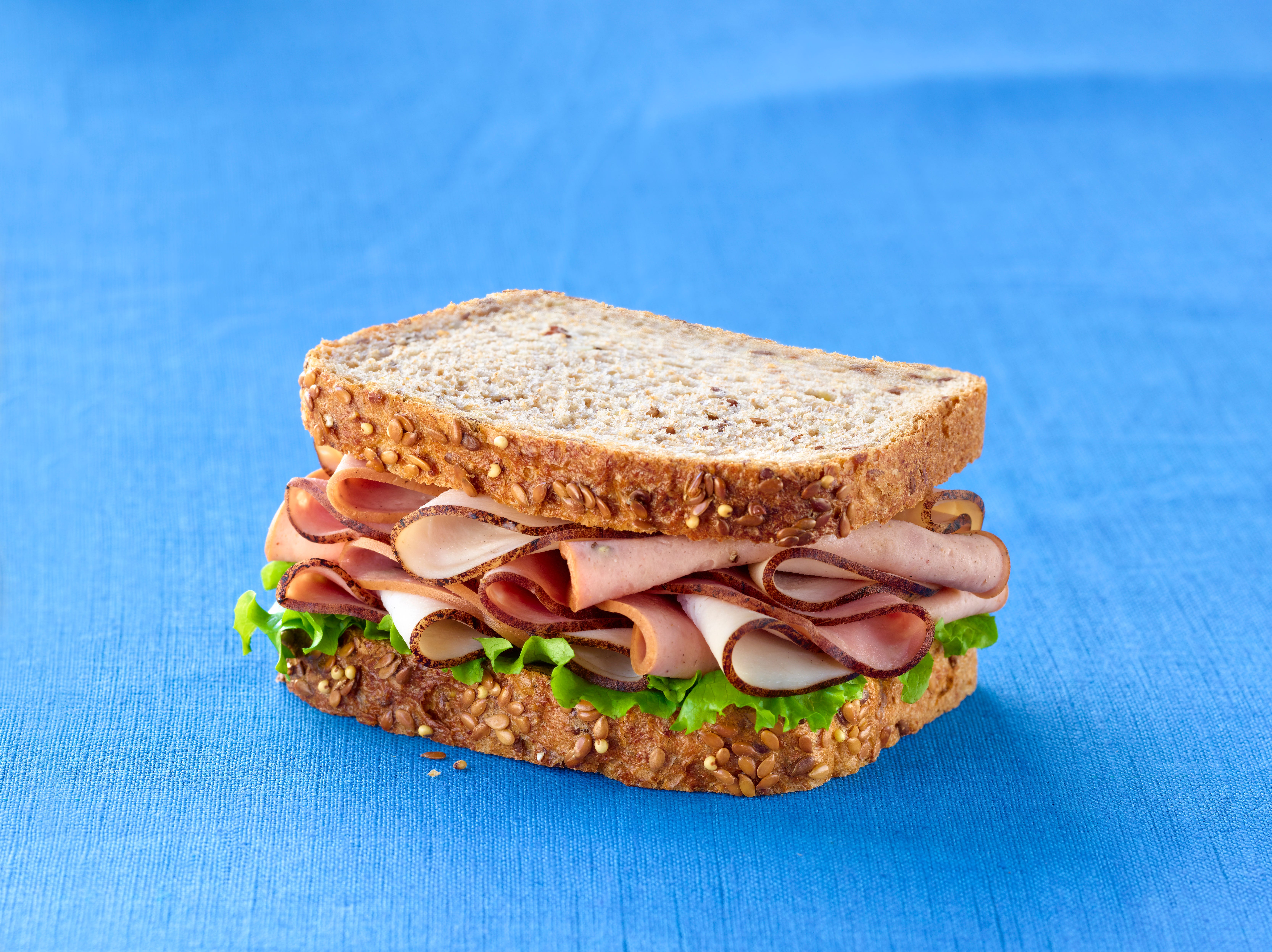 A sandwich on a tablecloth.