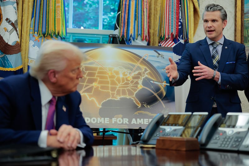 U.S. Defense Secretary Pete Hegseth (R) talks about the "Golden Dome" missile defense system with President Donald Trump in the Oval Office