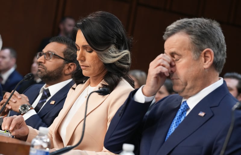 Director Kash Patel, Director of National Intelligence Tulsi Gabbard, and Central Intelligence Agency Director John Ratcliffe listen during a March intelligence hearing. Gabbard supports President Donald Trump using the Alien Enemies Act of 1798 to deport migrants without due process.