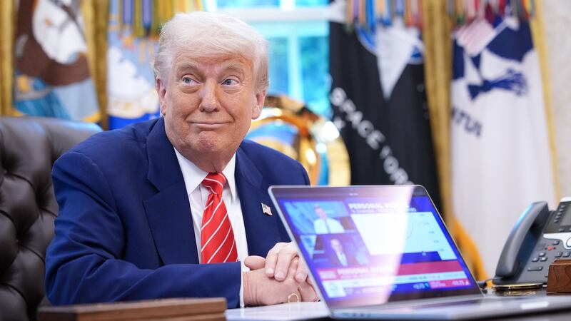 WASHINGTON, DC - MAY 30: U.S. President Donald Trump, joined by Tesla CEO Elon Musk, shows a news video from a laptop in the Oval Office of the White House on May 30, 2025 in Washington, DC. Musk, who served as an adviser to Trump and led the Department of Government Efficiency, announced he would leave his role in the Trump administration early this week to refocus on his businesses. (Photo by Kevin Dietsch/Getty Images)