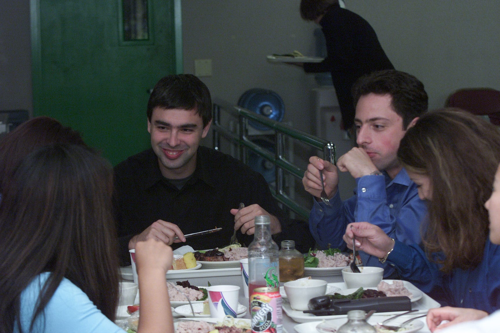 Larry Page (left) and Sergey Brin (right) eat lunch with early Google employees