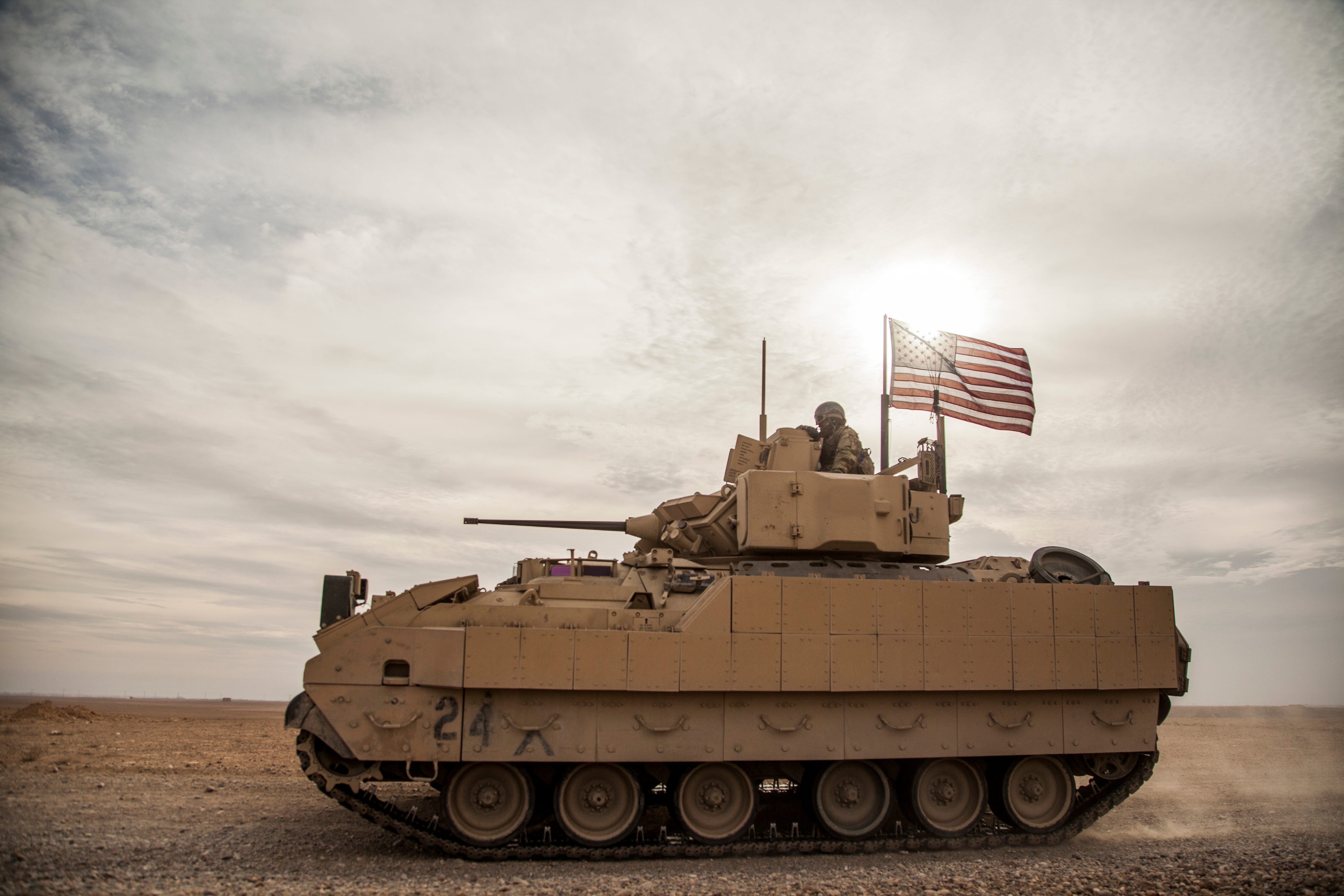 American soldiers drive a Bradley fighting vehicle during a joint exercise with Syrian Democratic Forces at the countryside of Deir Ezzor in northeastern Syria, Dec. 8, 2021.