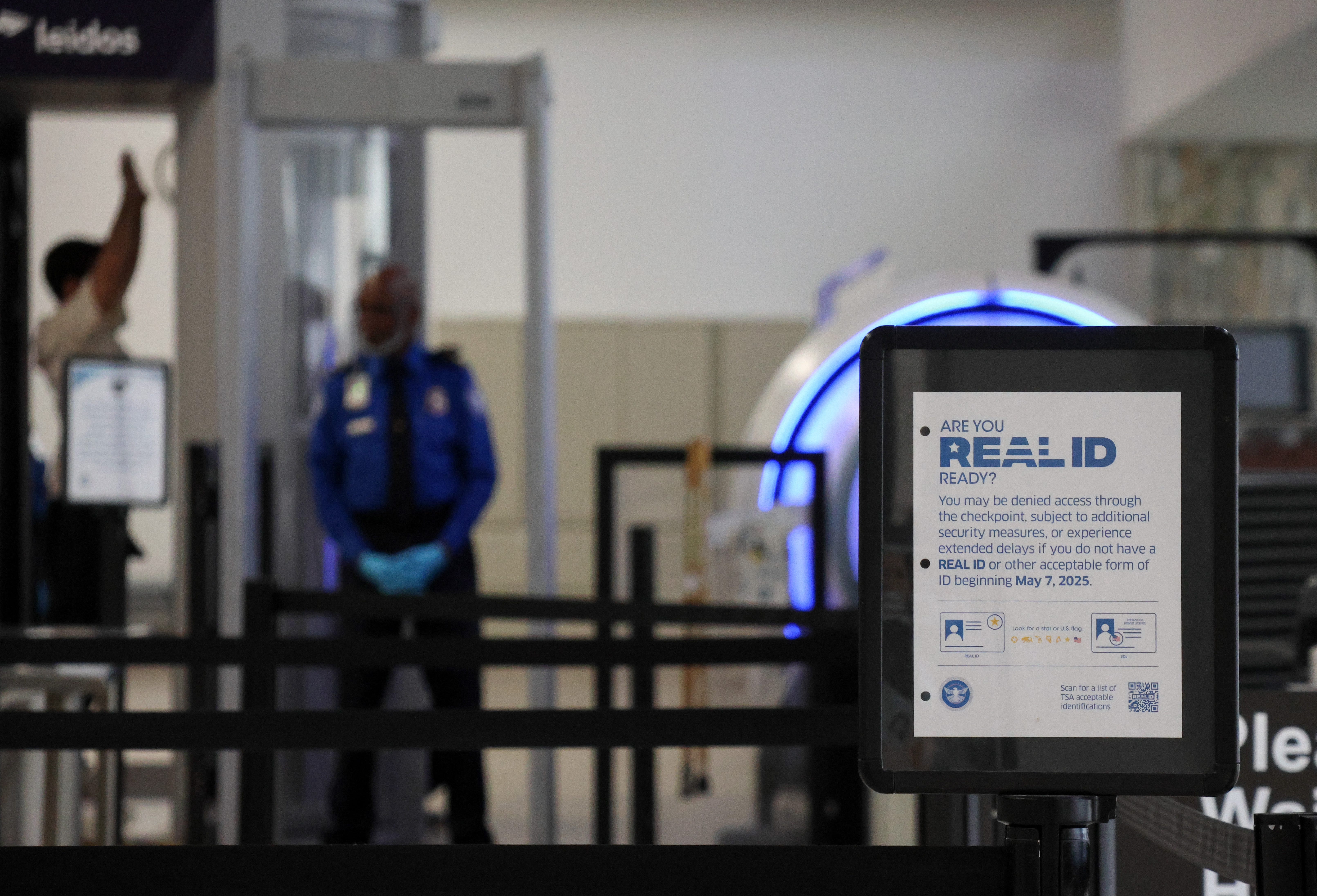 A sign at TSA informing travelers of Real IDs