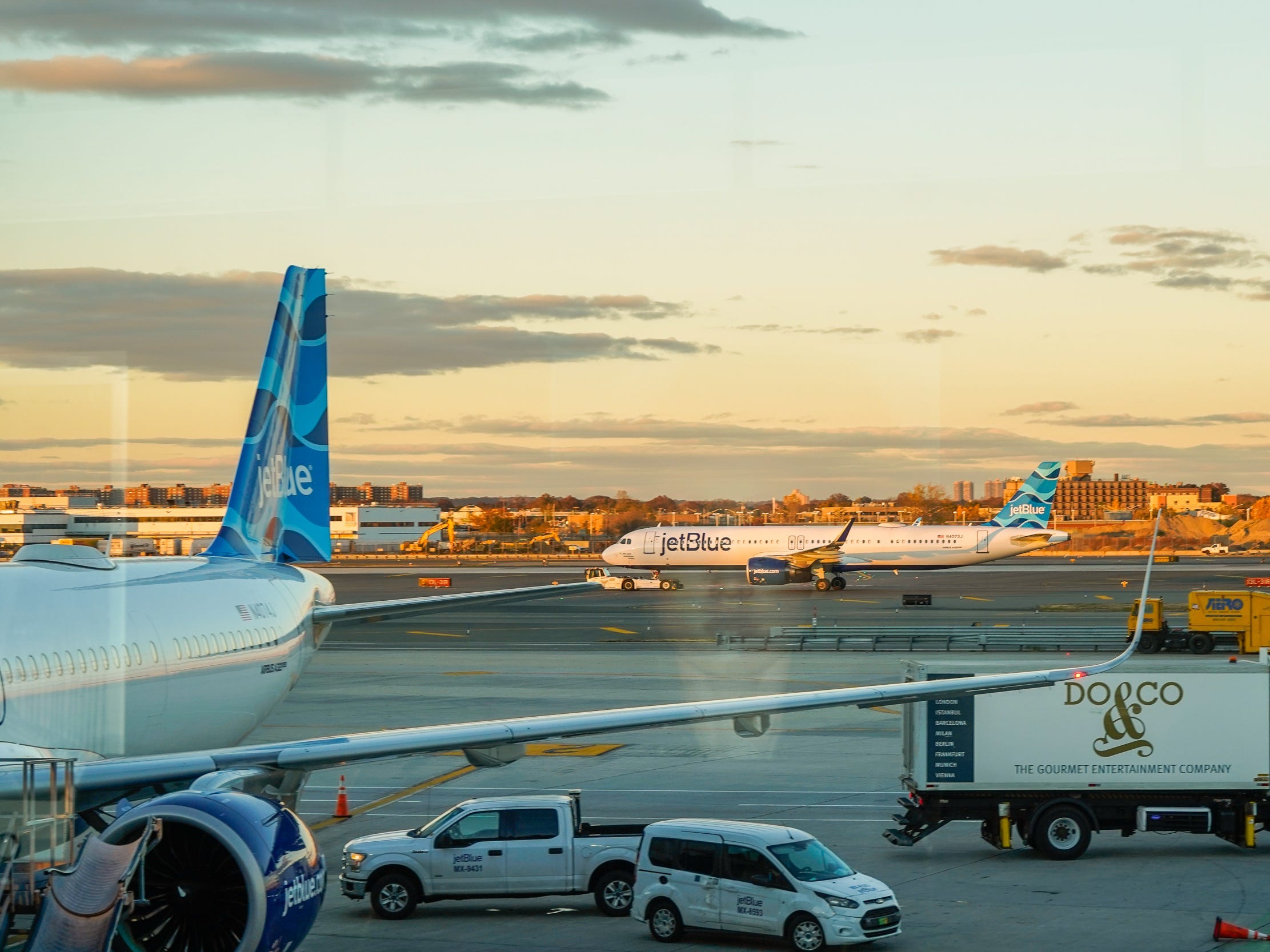 Jet blue planes on a tarmac during sunset
