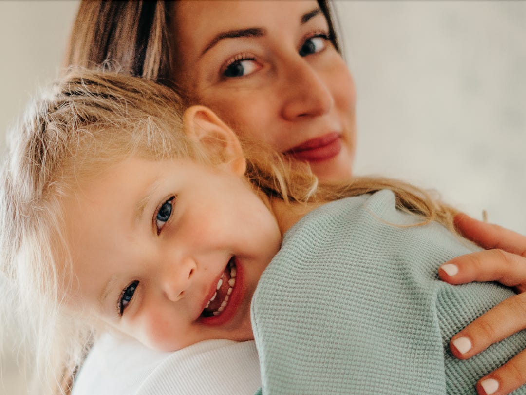 Mom and daughter posing for photo