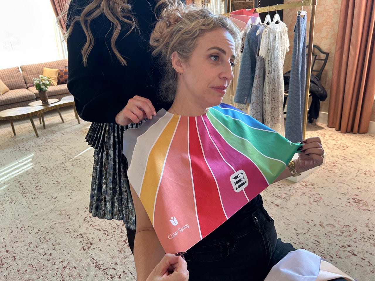 Author Alesandra Dubin looking sad, wearing a colorful mat draped on her by stylist