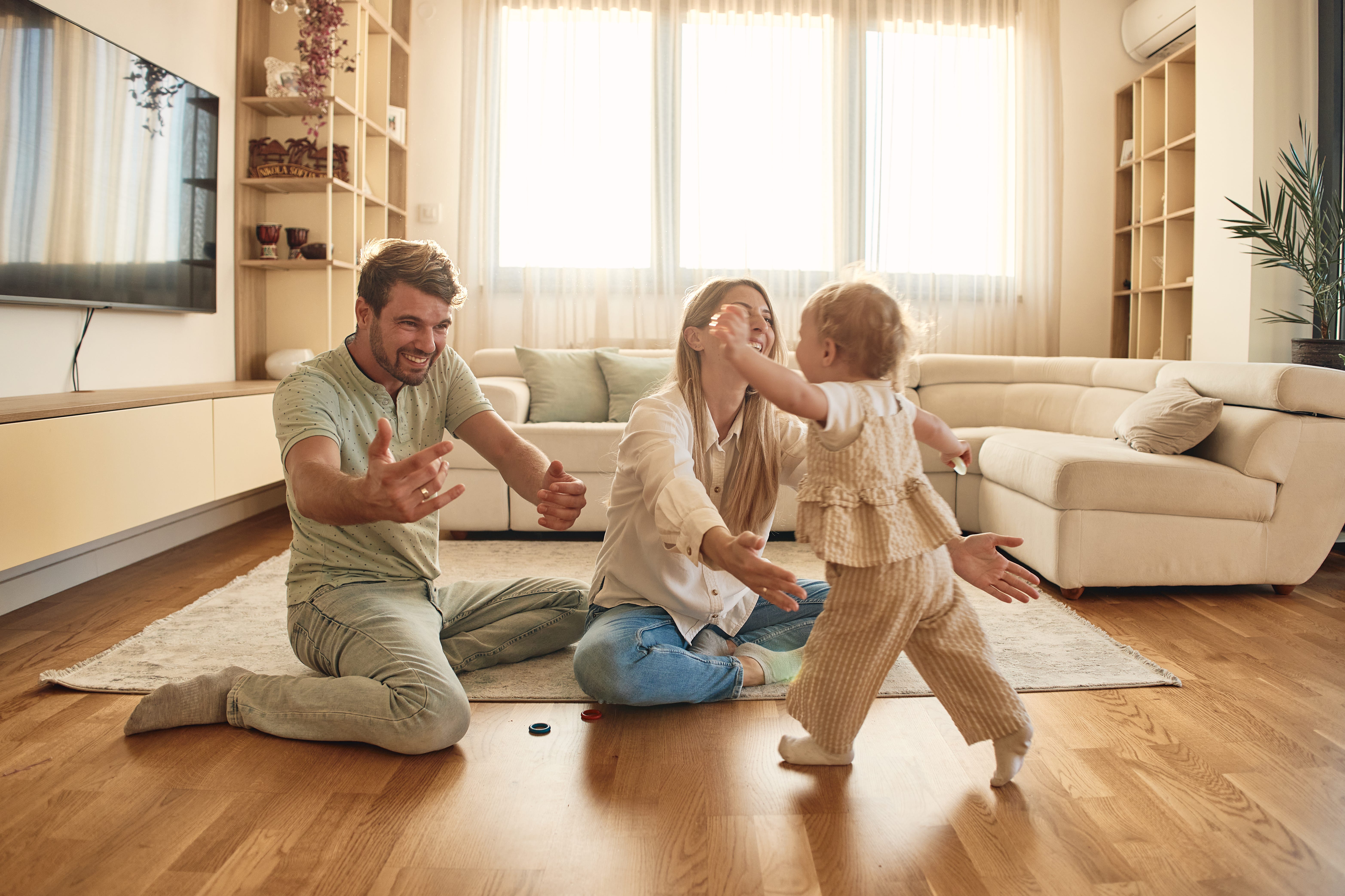 Playful young family enjoying the day. Mother and father with baby girl.