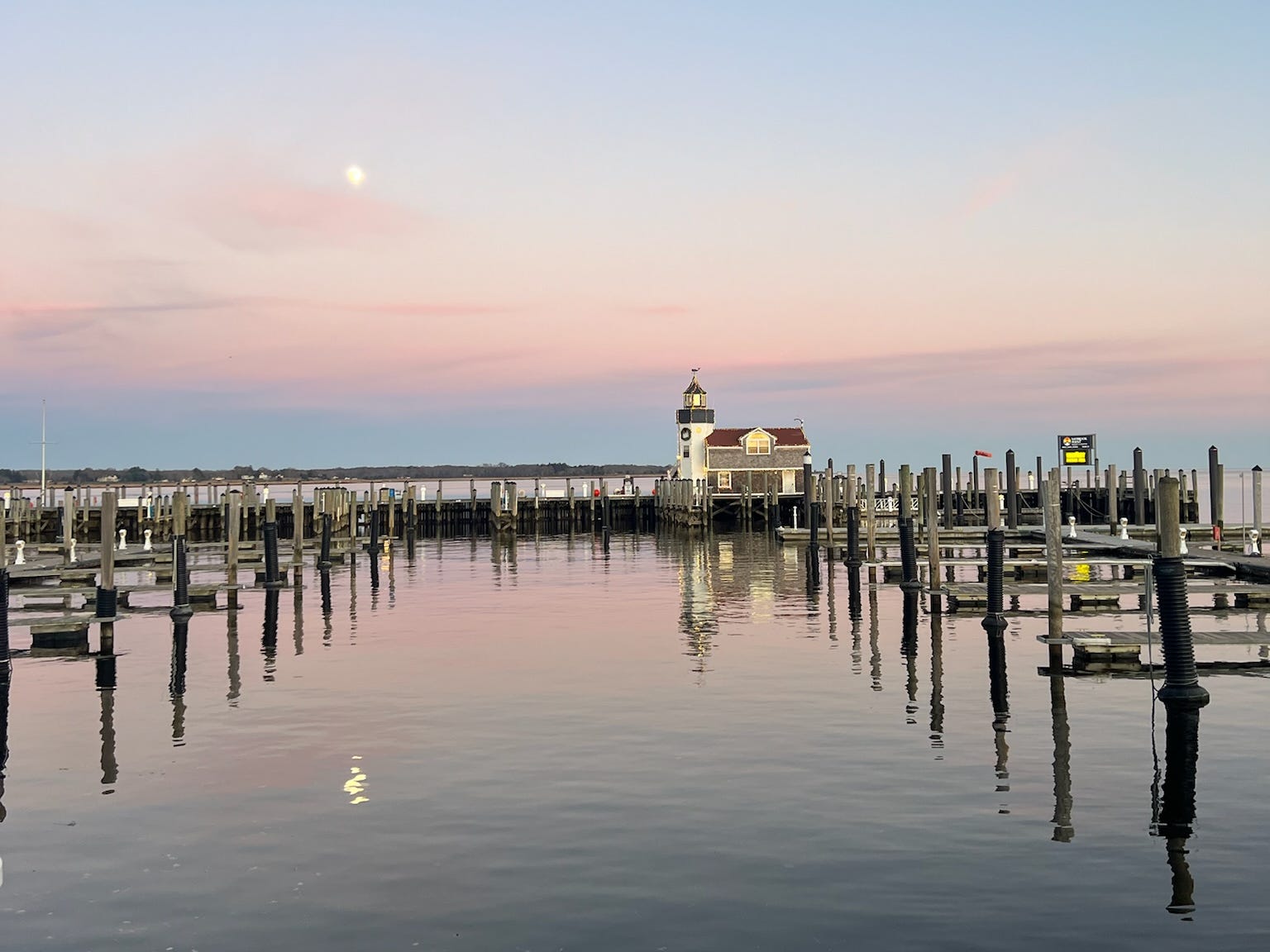 Docked boats in front of pink and purple skies in Old Saybrook