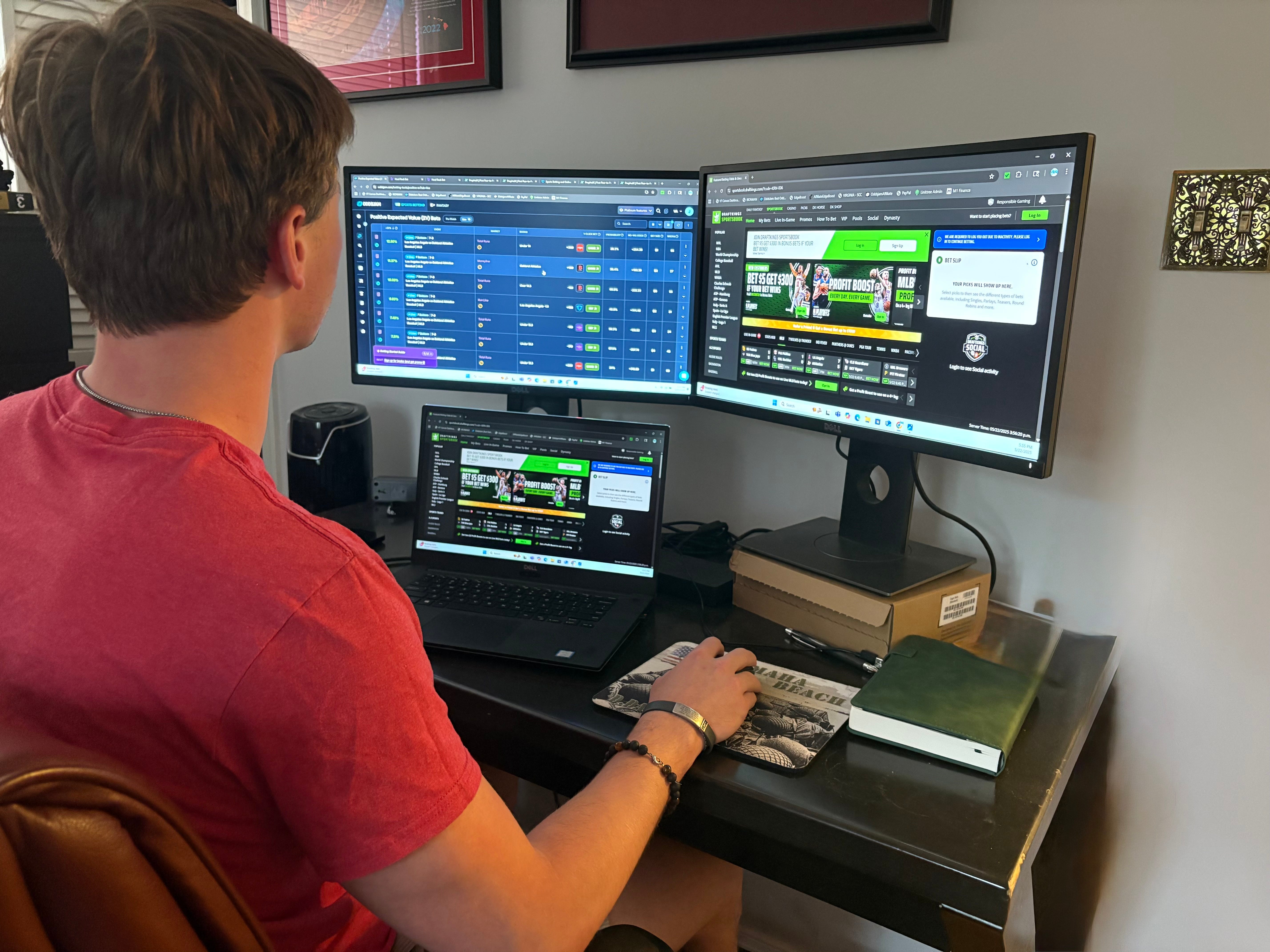 James Crosby sits at his desk with his sportsbook pages open.