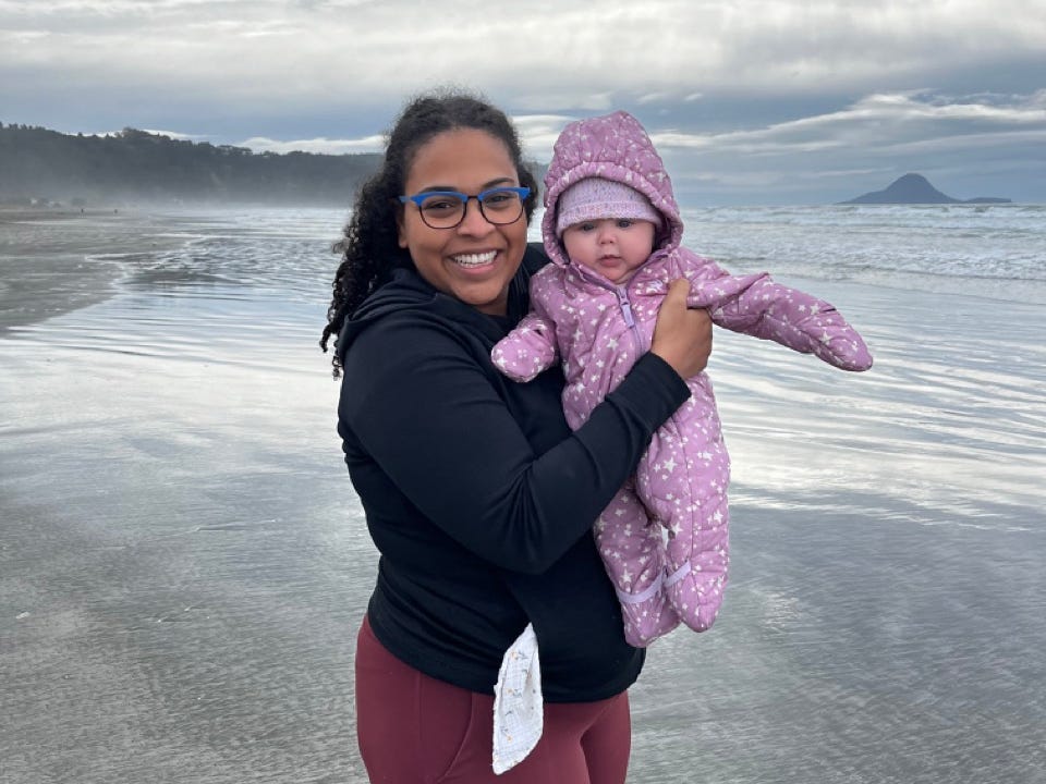 Author Alejandra Rojas holding her baby on a beach