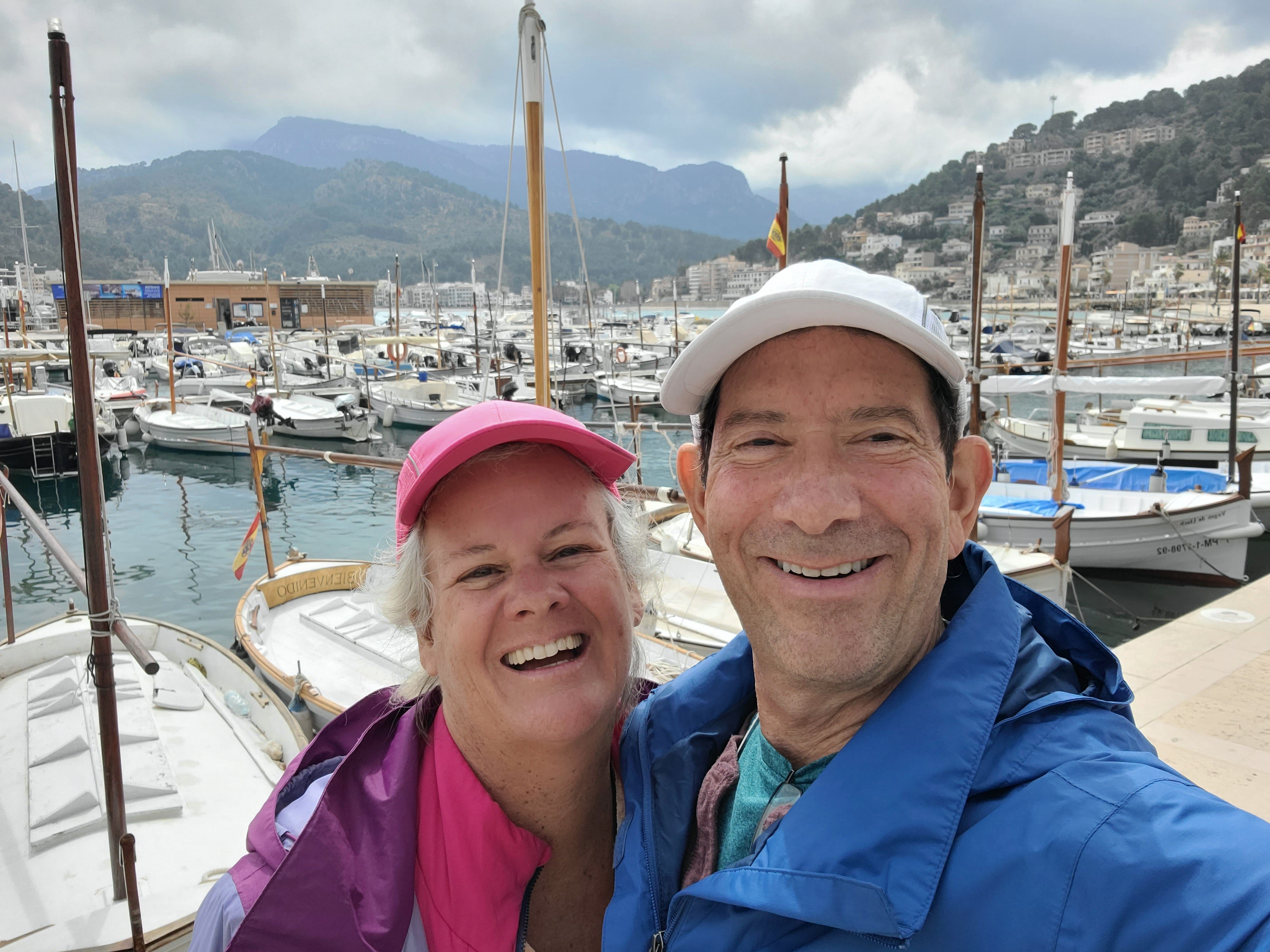 Author Chris Englert and husband smiling near dock of boats