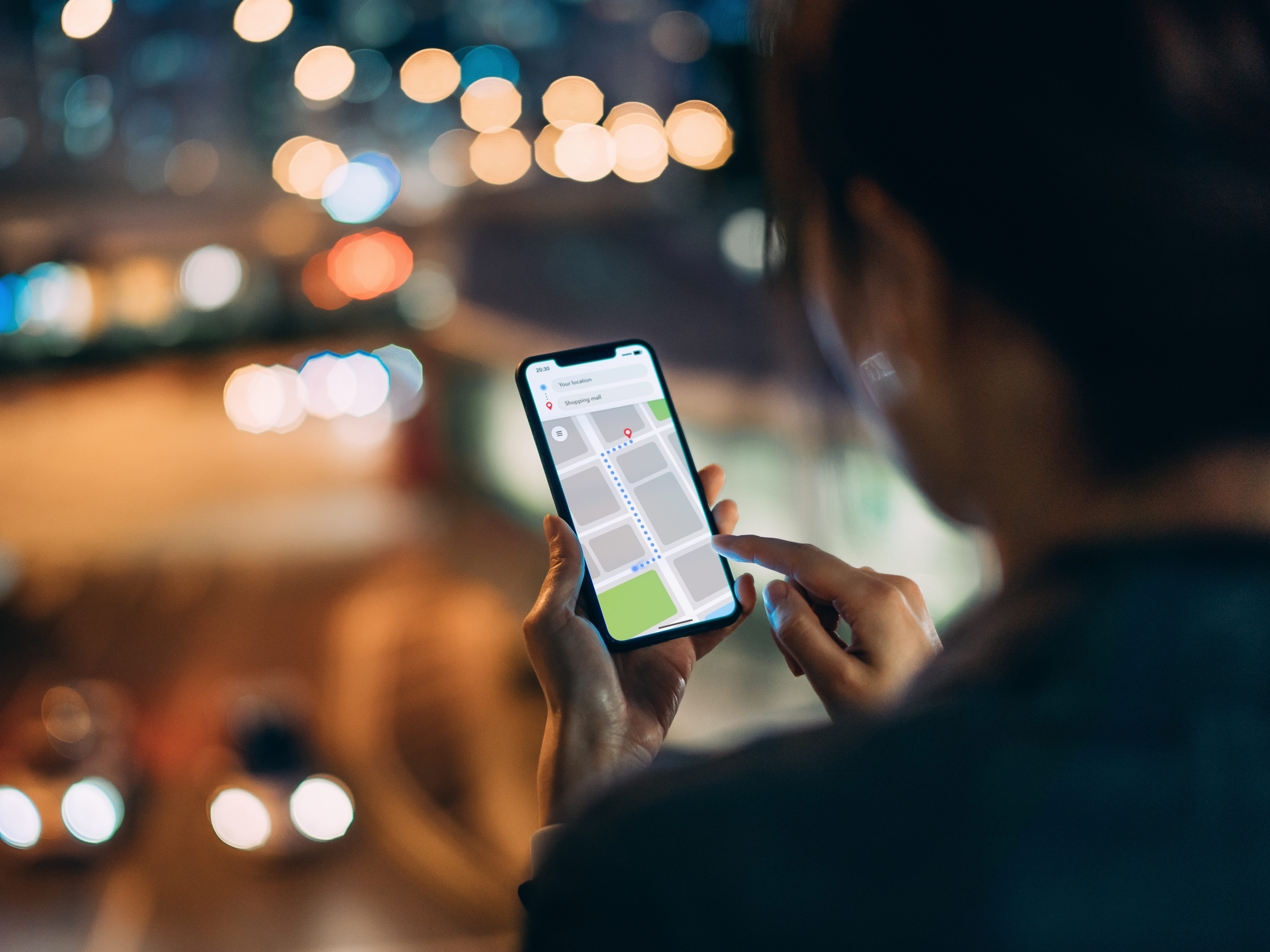 a blurred out woman looking at a tracking map on her phone